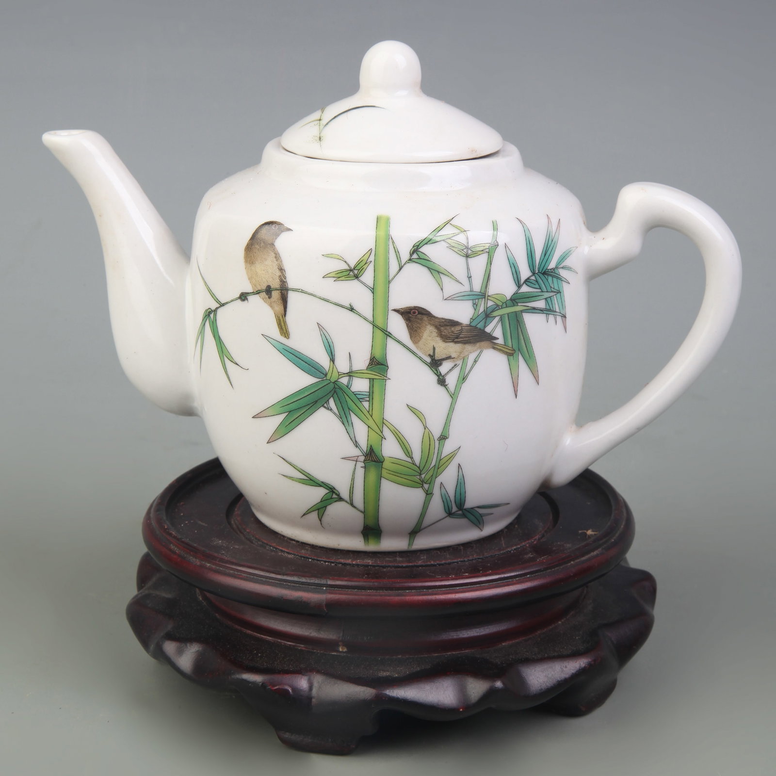 A FAMILLE ROSE TEAPOT WITH FLORAL AND BIRD DECORATION: Republic Period; Width: 6.6 inch; High: 4.3 inch; Woodbase for picture and display only