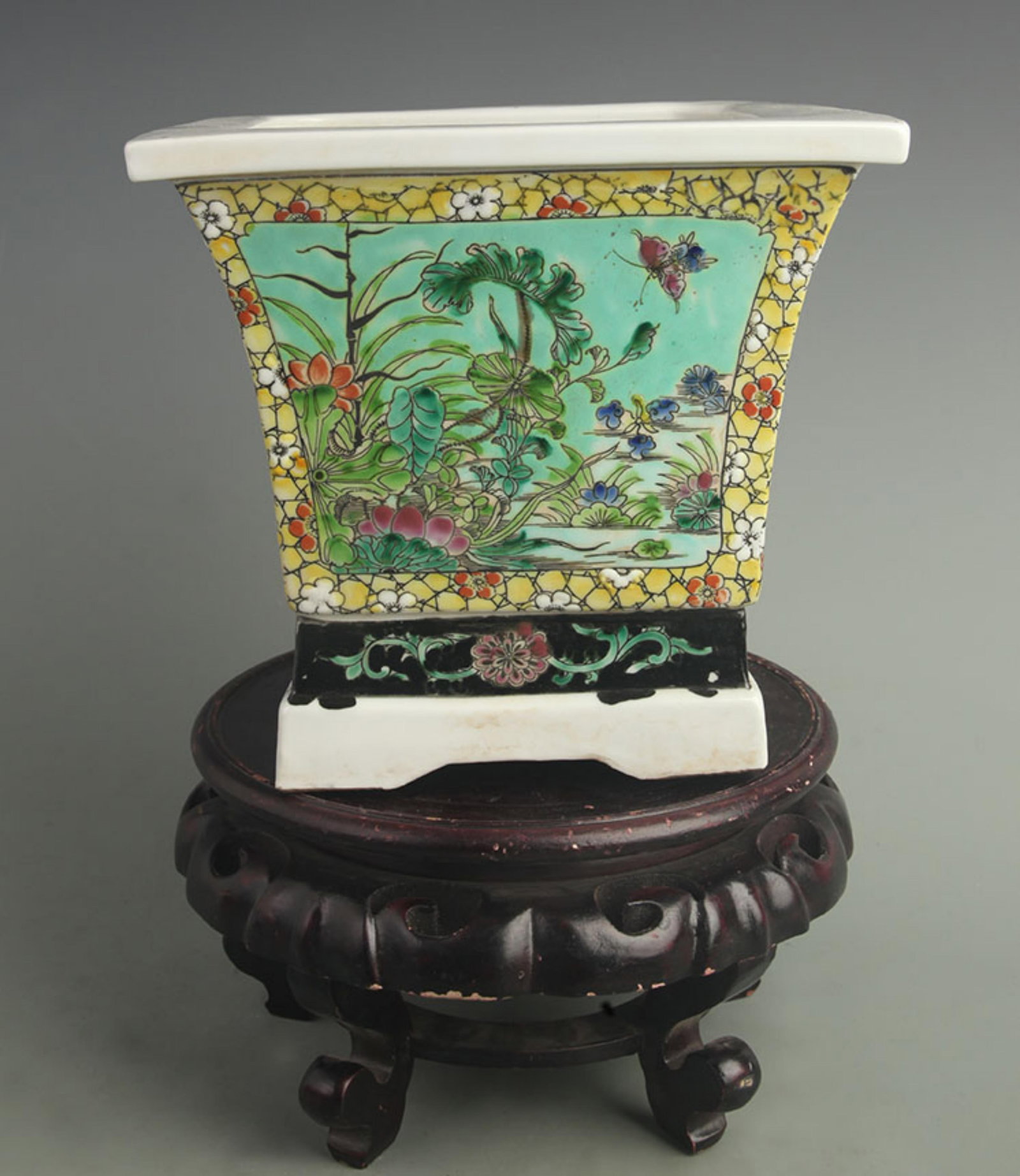 BLUE-GROUND FLOWERPOT WITH EIGHT TREASURES PANELS: Qing Dynasty; High: 8.00 inch; Diameter: 8.80 inch; Woodbase for picture and display only