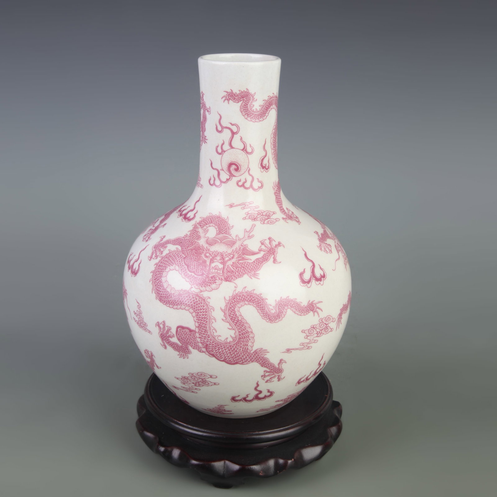 AN UNDERGLAZE-RED ‘DRAGON’ TIANQIUPING (GLOBULAR VASE): Qing Dynasty Qian Long Period; Diameter: 6.0 inch; High: 9.1 inch; Woodbase for picture and display only