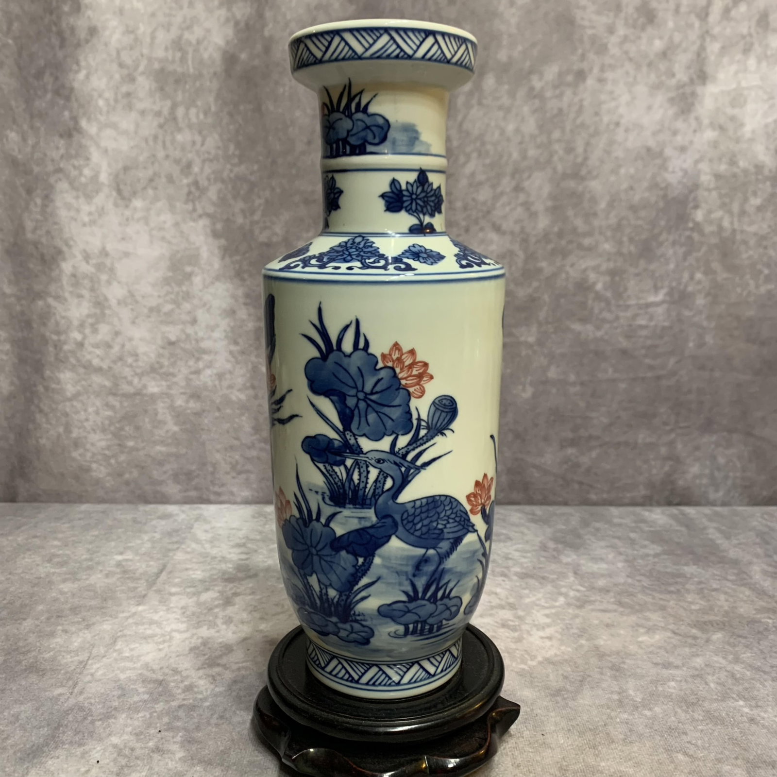 A SMALL BLUE-AND-WHITE ‘LOTUS’ PATTERN PORCELAIN VASE: 20th Century; High: 10.0 inch; Diameter: 3.8 inch; Woodbase for picture and display only