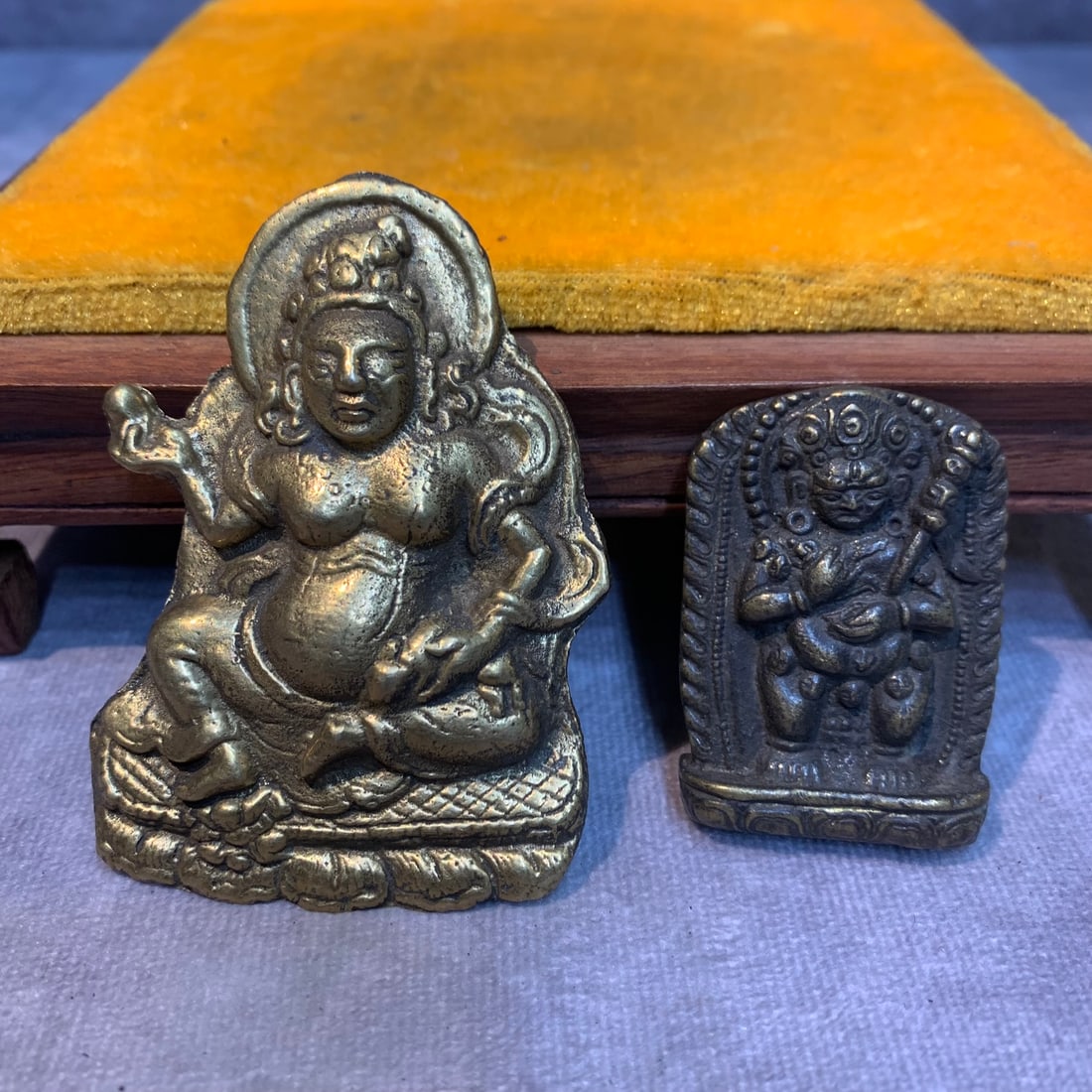 PAIR OF TIBETAN BUDDHA STATUE PENDANT: Modern; High: 3.0 inch; Width: 2.1 inch; High: 1.8 inch; Width: 1.3 inch; Woodbase for picture and display only