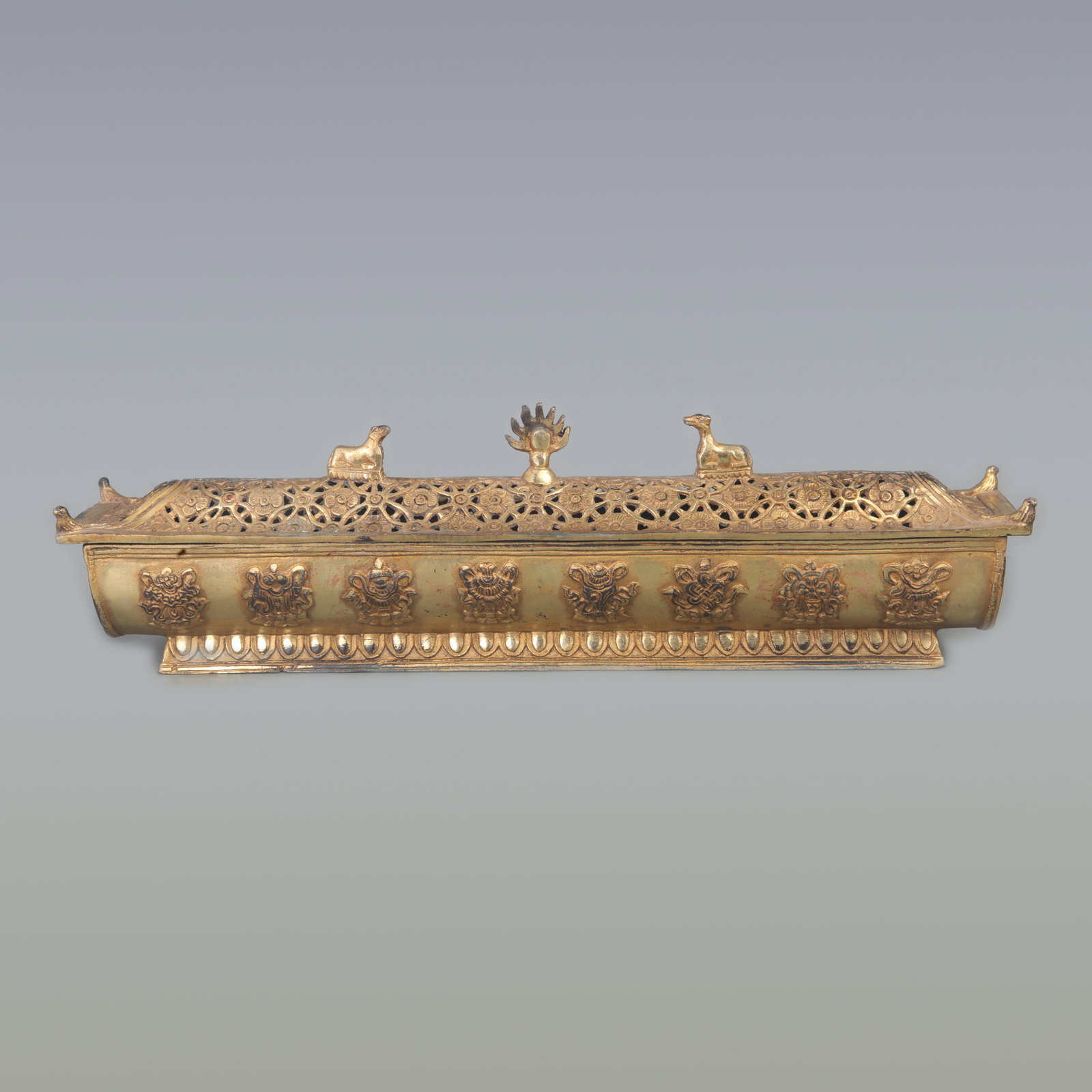 A GILT-BRONZE ‘EIGHT TREASURES’ HORIZONTAL INCENSE BURNER: Ming Dynasty Style; Long: 15.3 inch; Width: 3.2 inch; High: 2.5 inch; Woodbase for picture and display only