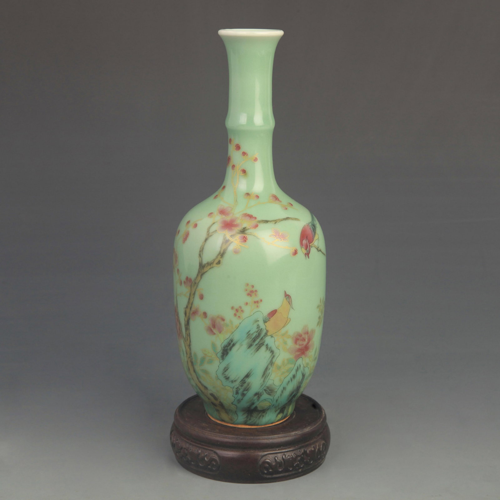 A FAMILLE ROSE BLUE-GROUND PHOENIX MOTIF LONG-NECK VASE: Qing Dynasty Qian Long Period; High: 9.50 inch; Diameter: 3.50 inch; Woodbase for picture and display only
