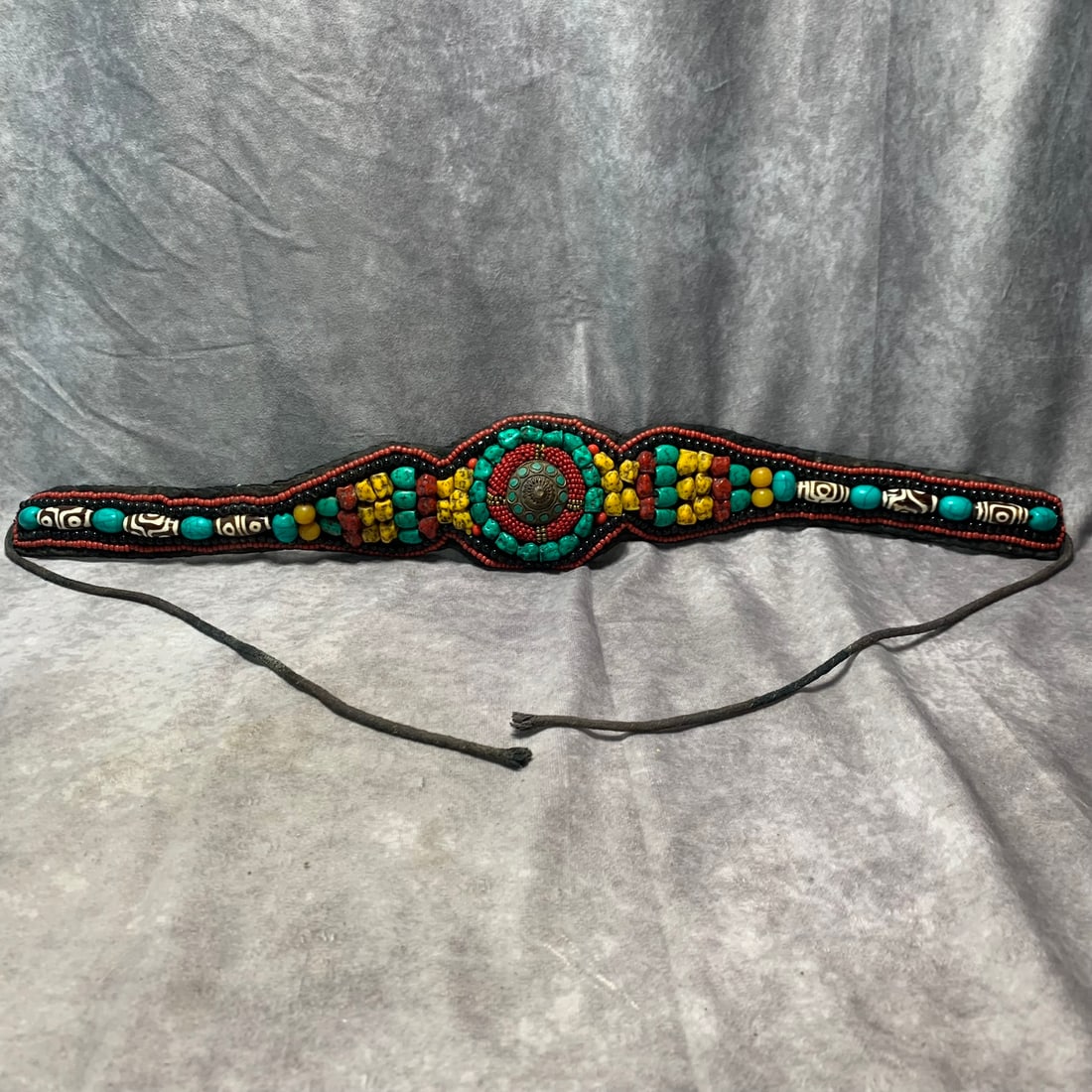 MODERN TIBETAN BRONZE-INLAID BELT WITH TURQUOISE, CORAL, AND OTHER GEMSTONES: Modern; Long: 24.5 inch Width: 3.5 inch; Woodbase for picture and display only