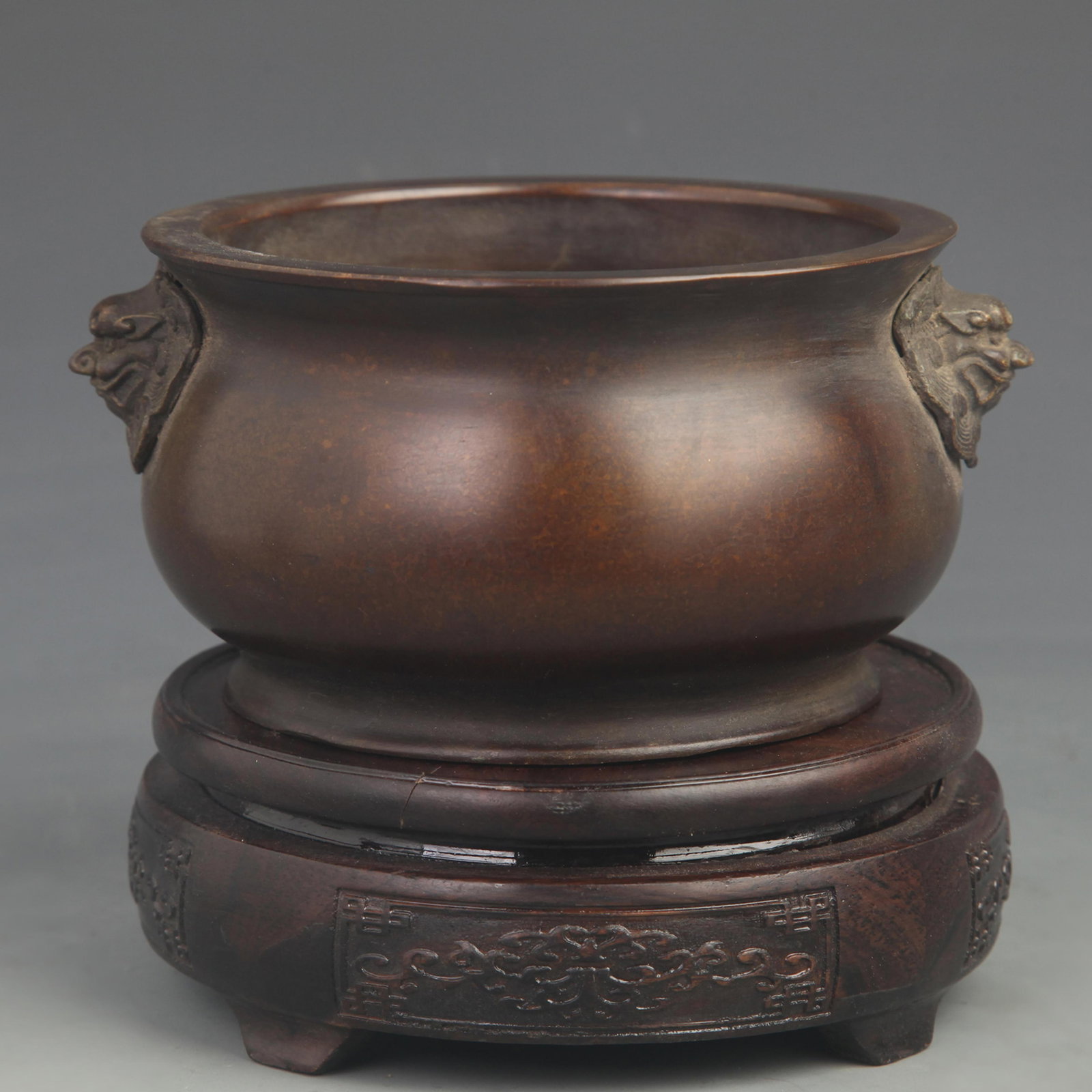 A FINE BRONZE LION HANDLE PATTERN CENSER: 20th Century; High: 3.00 inch; Diameter: 5.00 inch; Woodbase for picture and display only
