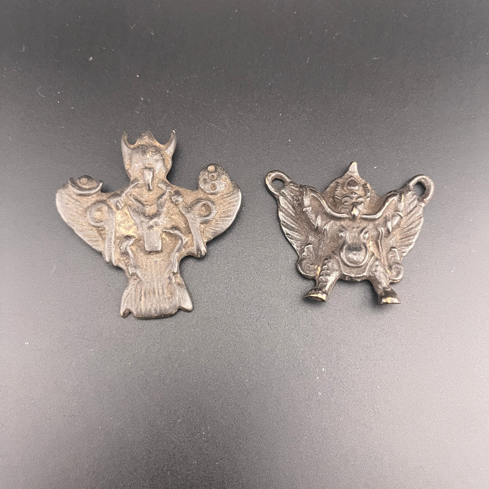 GROUP OF TWO TIBETAN RITUAL AMULET PENDANT: ; Long: 1.9 inch; Width:1.7 inch; Heigh: 0.2 inch; Long: 2 inch; Width:2.1 inch; Heigh: 0.3 inch; Woodbase for picture and display only