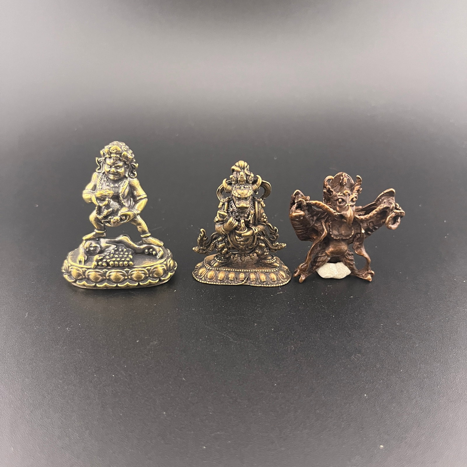 GROUP OF THREE TIBETAN RITUAL AMULET PENDANT: Modern; Long: 1.5 inch; Width:0.76 inch; Heigh: 1.84 inch; Long: 1.3 inch; Width:0.5 inch; Heigh: 1.68 inch; Long: 1.6 inch; Width:1.5 inch; Heigh: 0.6 inch; Woodbase for picture and display only
