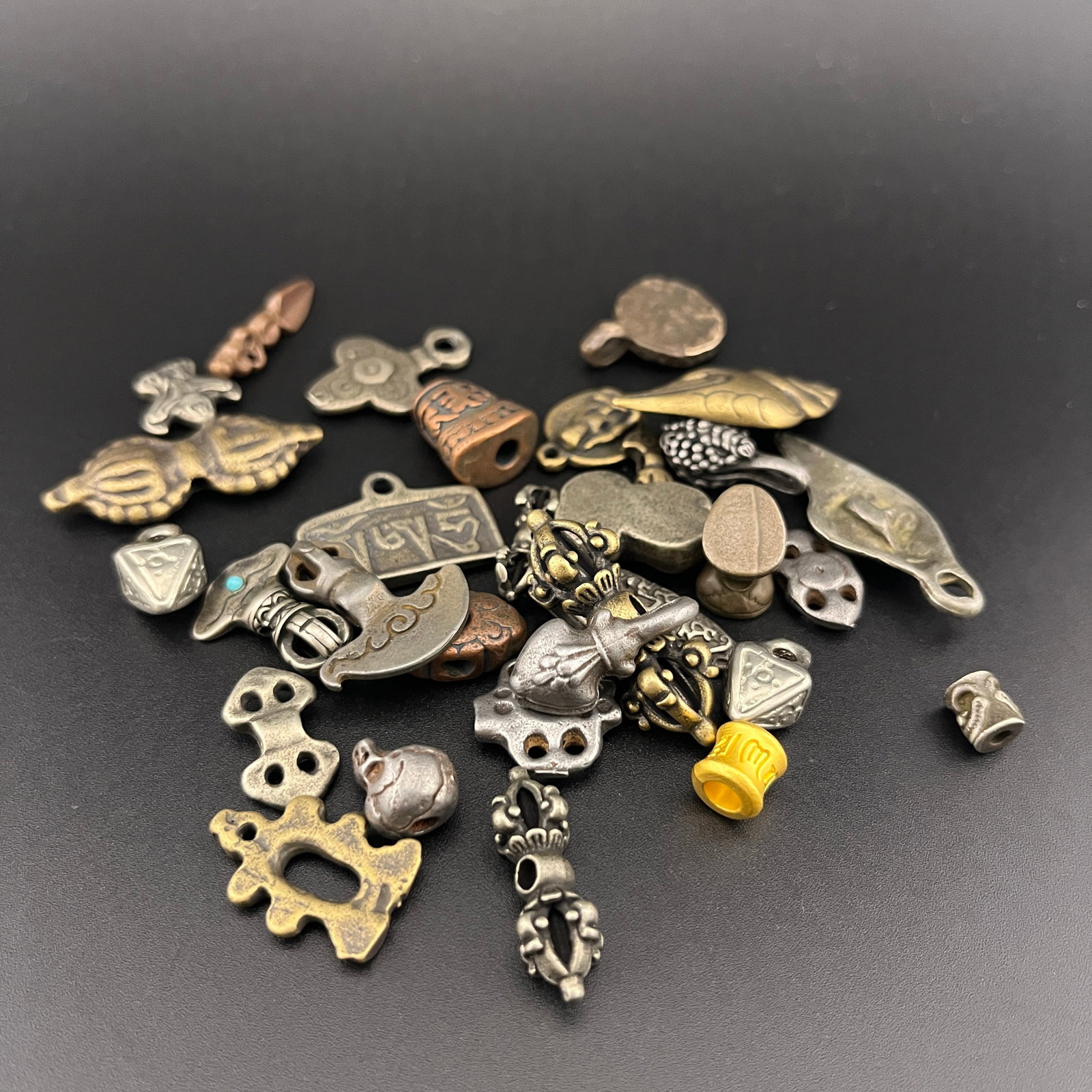GROUP OF SMALL TIBETAN BUDDHIST PENDANT: Modern; Long: 0.3 inch to 1.5 inch; Width:0.25 inch to 0.8 inch; Heigh: 0.15 inch; Woodbase for picture and display only