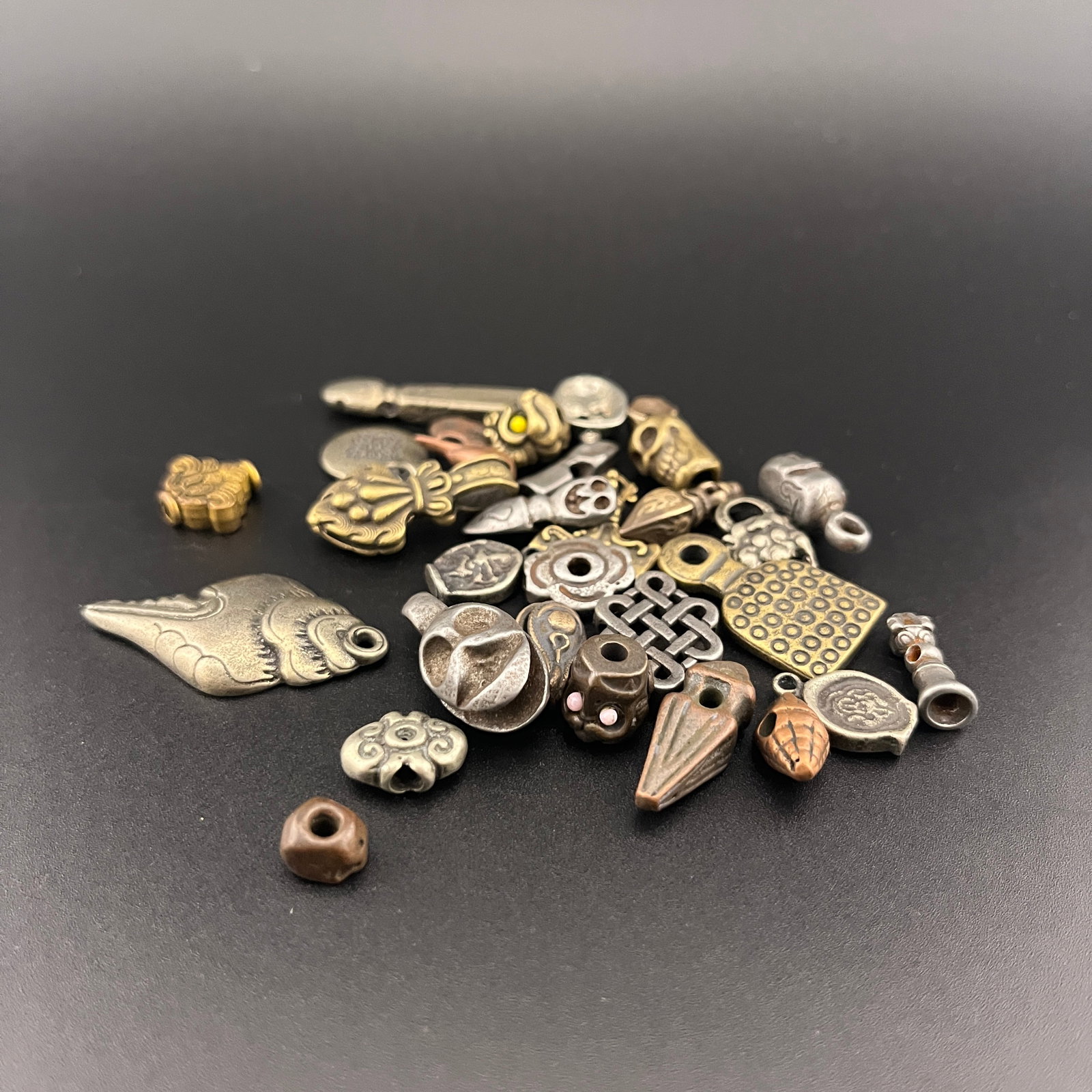 GROUP OF SMALL TIBETAN BUDDHIST PENDANT: Modern; Long: 0.3 inch to 1.5 inch; Width: 0.28 inch to 0.8 inch; Heigh: 0.18 inch to 0.22 inch ; Woodbase for picture and display only
