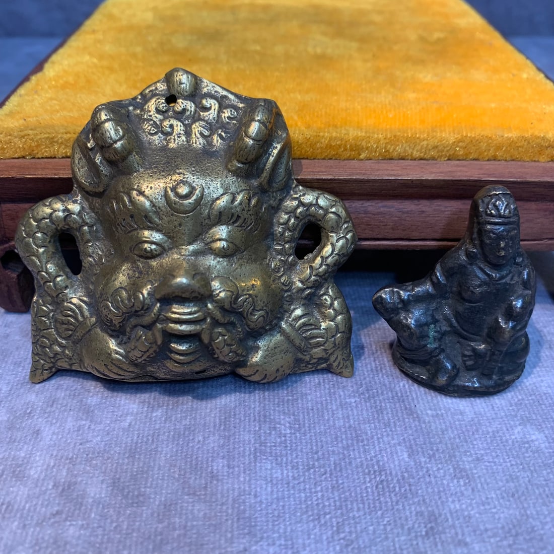 GROUP OF TWO SMALL BRONZE TIBETAN PENDANT: Modern; High: 2.7 inch; Width: 3.0 inch. High: 1.8 inch; Width: 1.4 inch; Woodbase for picture and display only