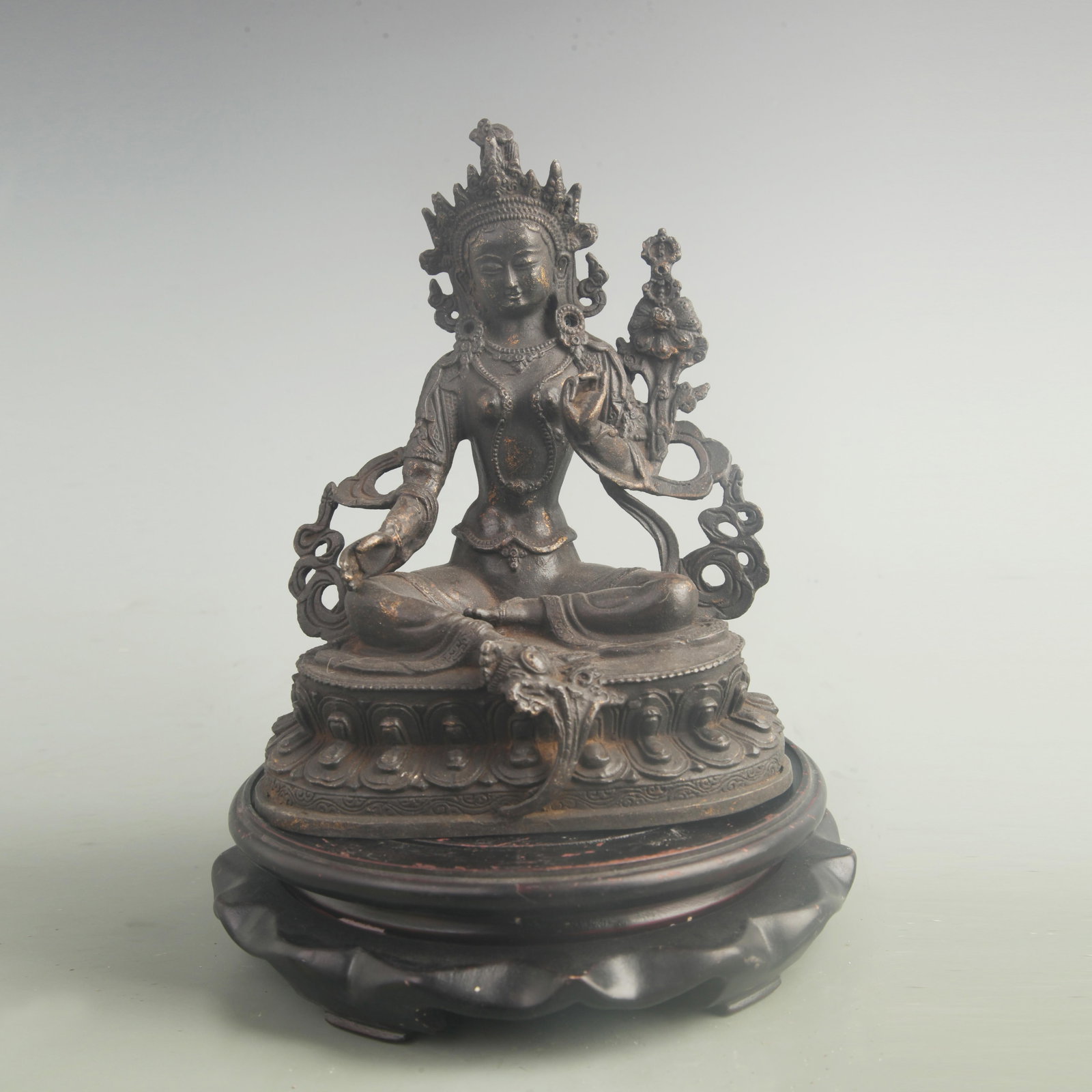 A GILT BRONZE SEATED GREEN TARA FIGURE: 19th Century; High: 8.00 inch; Width: 5.80 inch; Woodbase for picture and display only