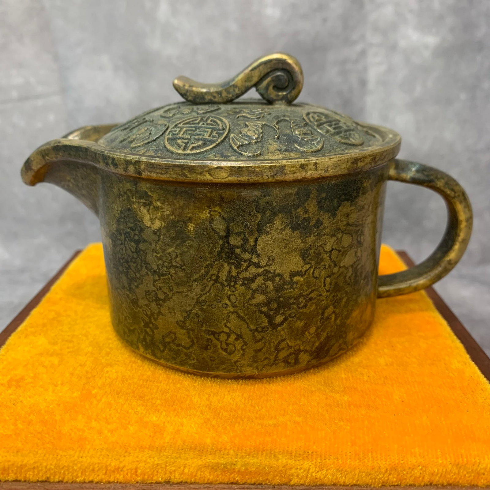 A FINELY CARVED BRONZE EWER: 20th Century; High: 3.4 inch; Diameter: 3.8 inch; Woodbase for picture and display only