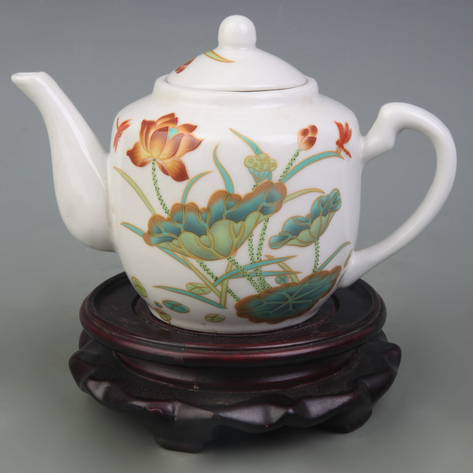 A FAMILLE-ROSE FLORAL AND BIRD TEAPOT: Republic Period; Width: 6.6 inch; High: 4.3 inch; Woodbase for picture and display only