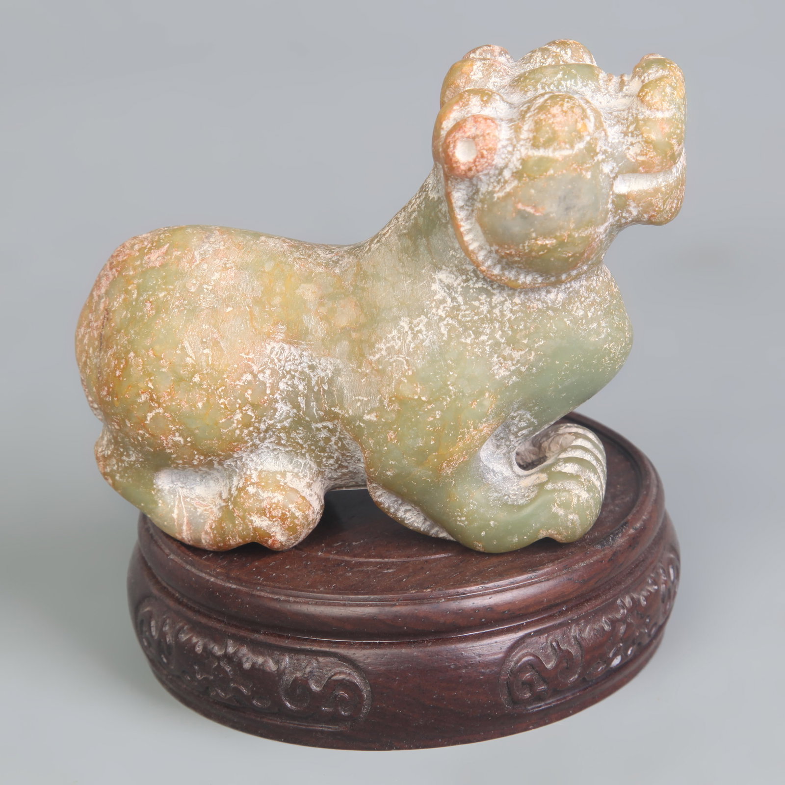 A FINE CELADON JADE CARVING IN FIGURE OF BIXIE (1 of 5)