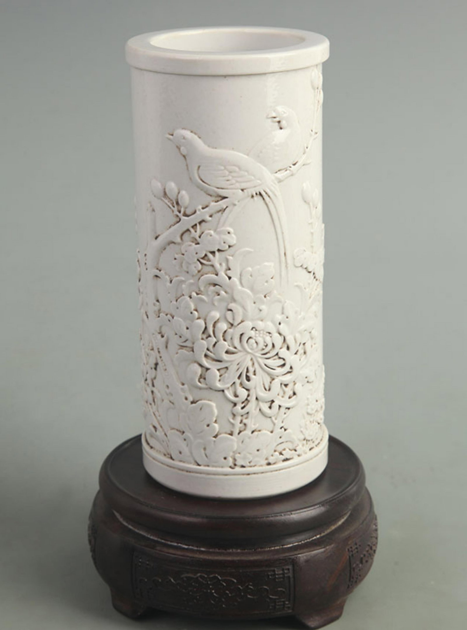 A WANG BINGRONG CARVED BRUSH POT WITH MAGPIE AND PLUM BLOSSOM MOTIF: Qing Dynasty; High: 6.80 inch; Diameter: 3.00 inch; Woodbase for picture and display only
