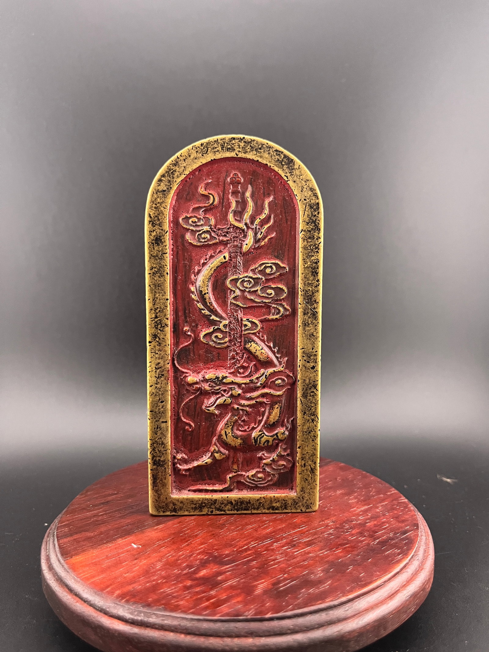 A HEAVY BRONZE TAOIST DRAGON-COILING SWORD PLAQUE: Modern; Long: 5.1 inch; Width:2.3 inch; Heigh: 0.4 inch; Woodbase for picture and display only