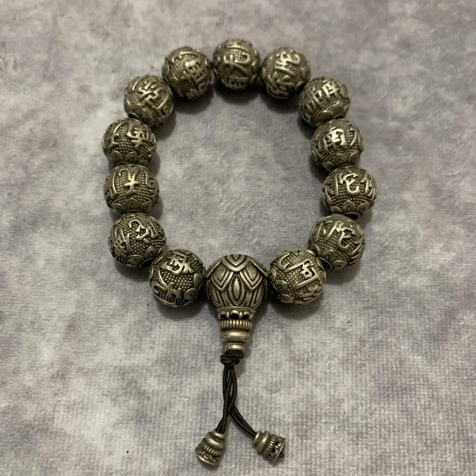 A FINE WHITE BRONZE FINELY CARVED BRACELETS: Modern, Long: 2.0 inch; Each Diameter: 0.5 inch; Woodbase for picture and display only