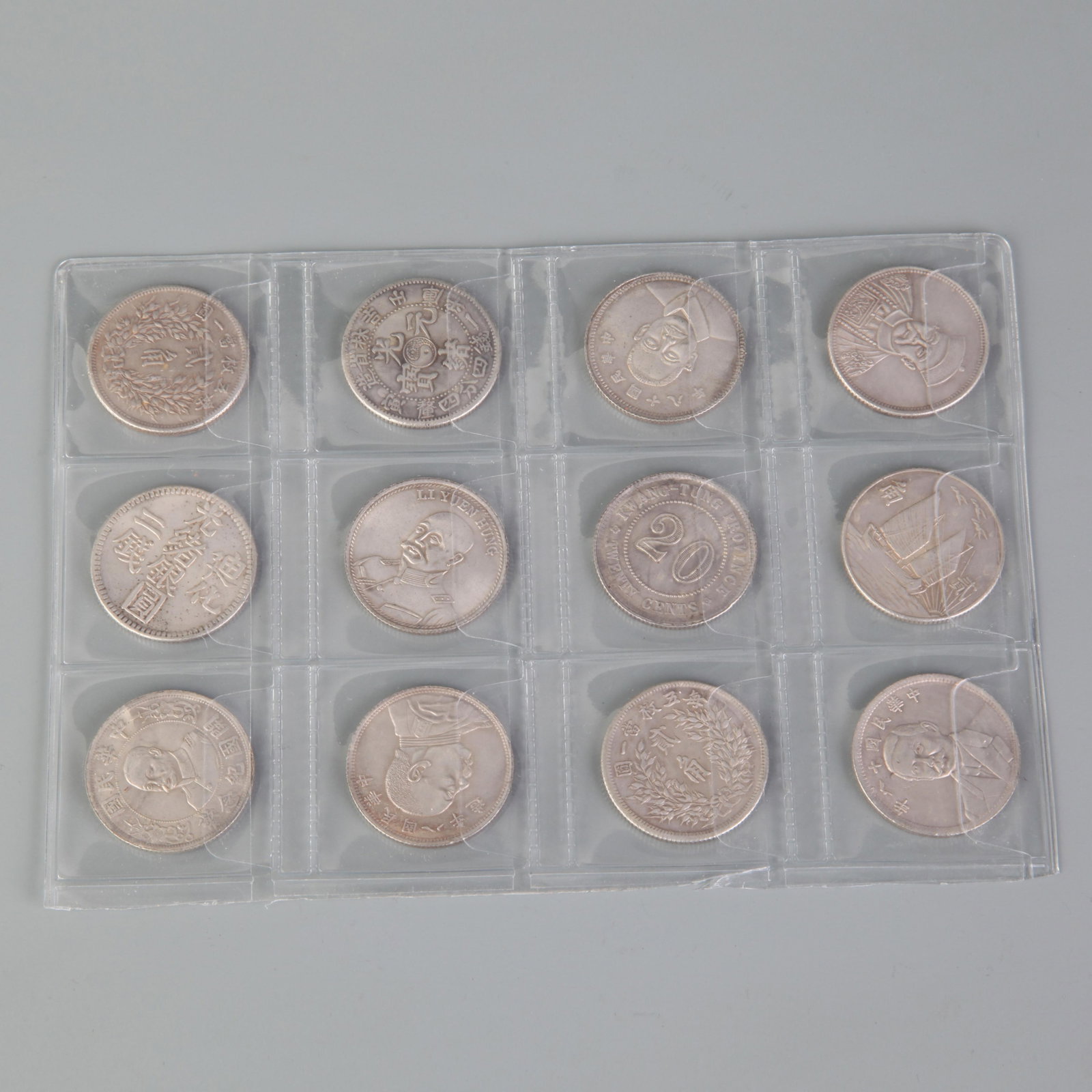GROUO OF TWELVE CHINESE COIN COLLECTION: Republic Period; Diameter: 1.0 inch; Woodbase for picture and display only