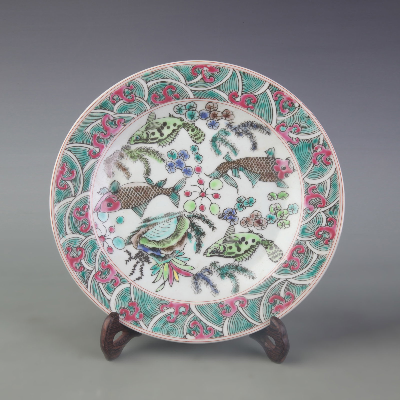 A FAMILLE ROSE FISH-AND-AQUATIC MOTIF PORCELAIN PLATE: Qing Dynasty Yong Zheng Period; Diameter: 9.0 inch; Woodbase for picture and display only