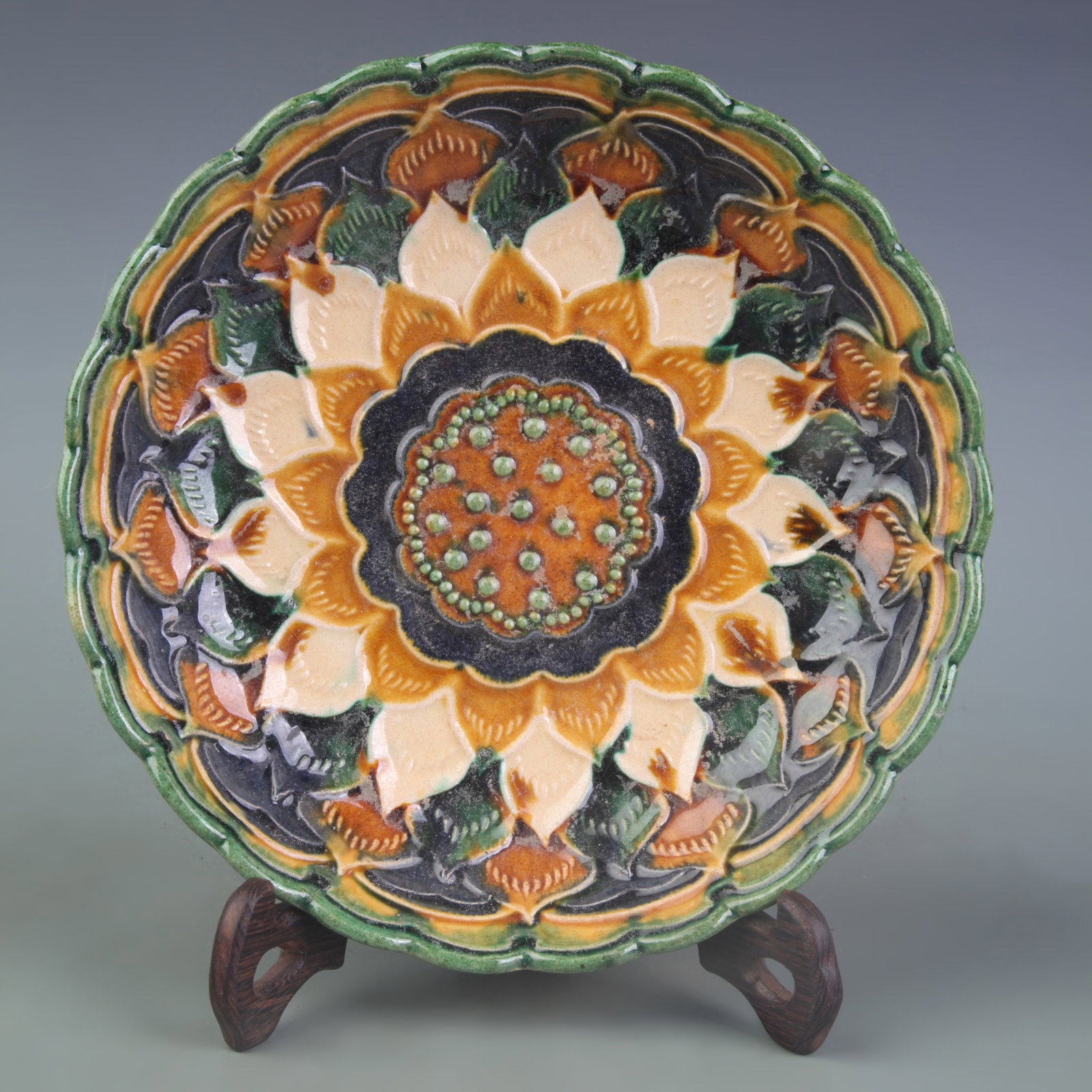 SANCAI GLAZED FLORAL PATTERN PORCELAIN PLATE: Tang Dynasty Style; Diameter: 8.2 inch; Wooden base for picture and display only.