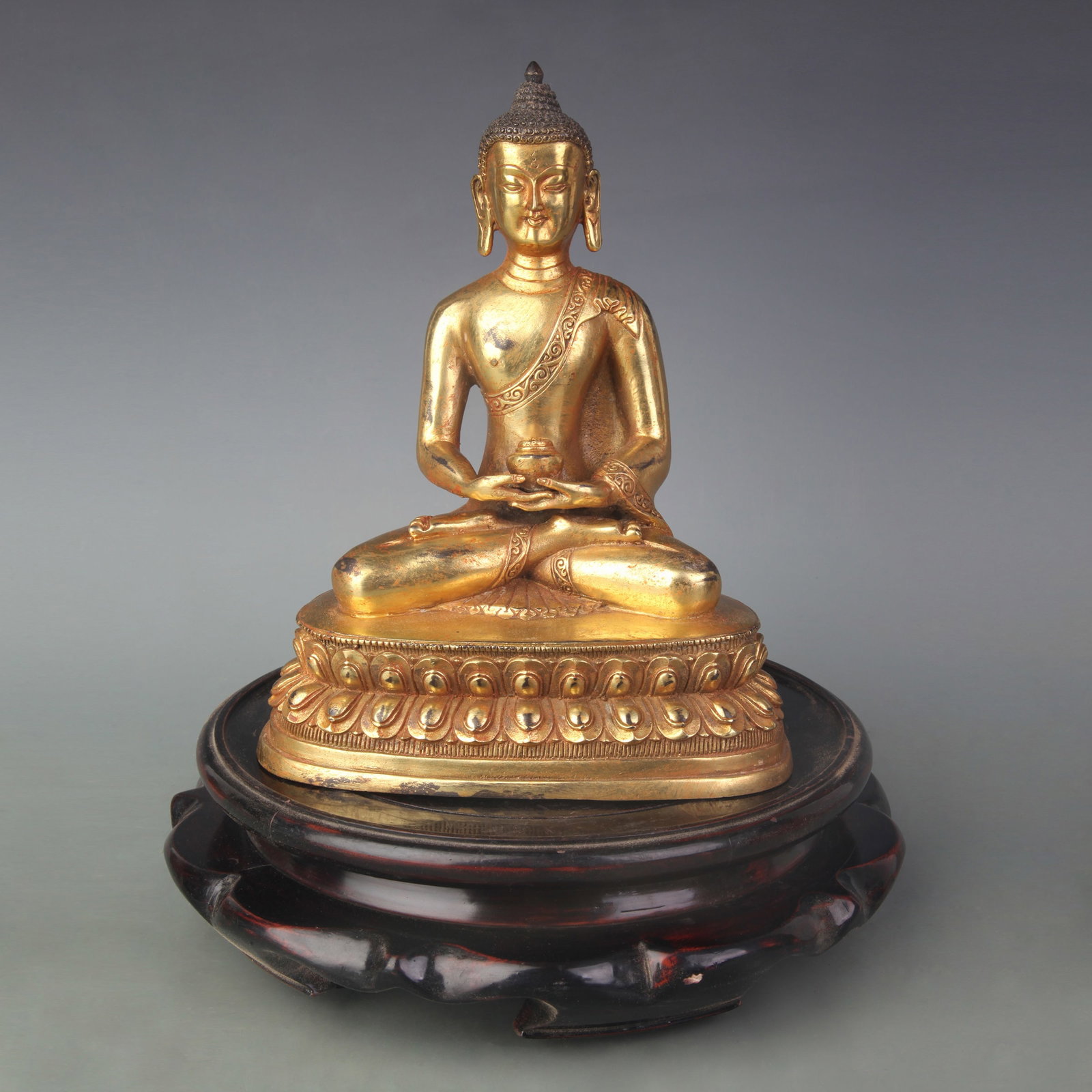 A FINE GILT BRONZE SHAKYAMUNI BUDDHA: Qing Dynasty; Width: 6.9 inch; High: 8.7 inch. Wooden base for picture and display only.
