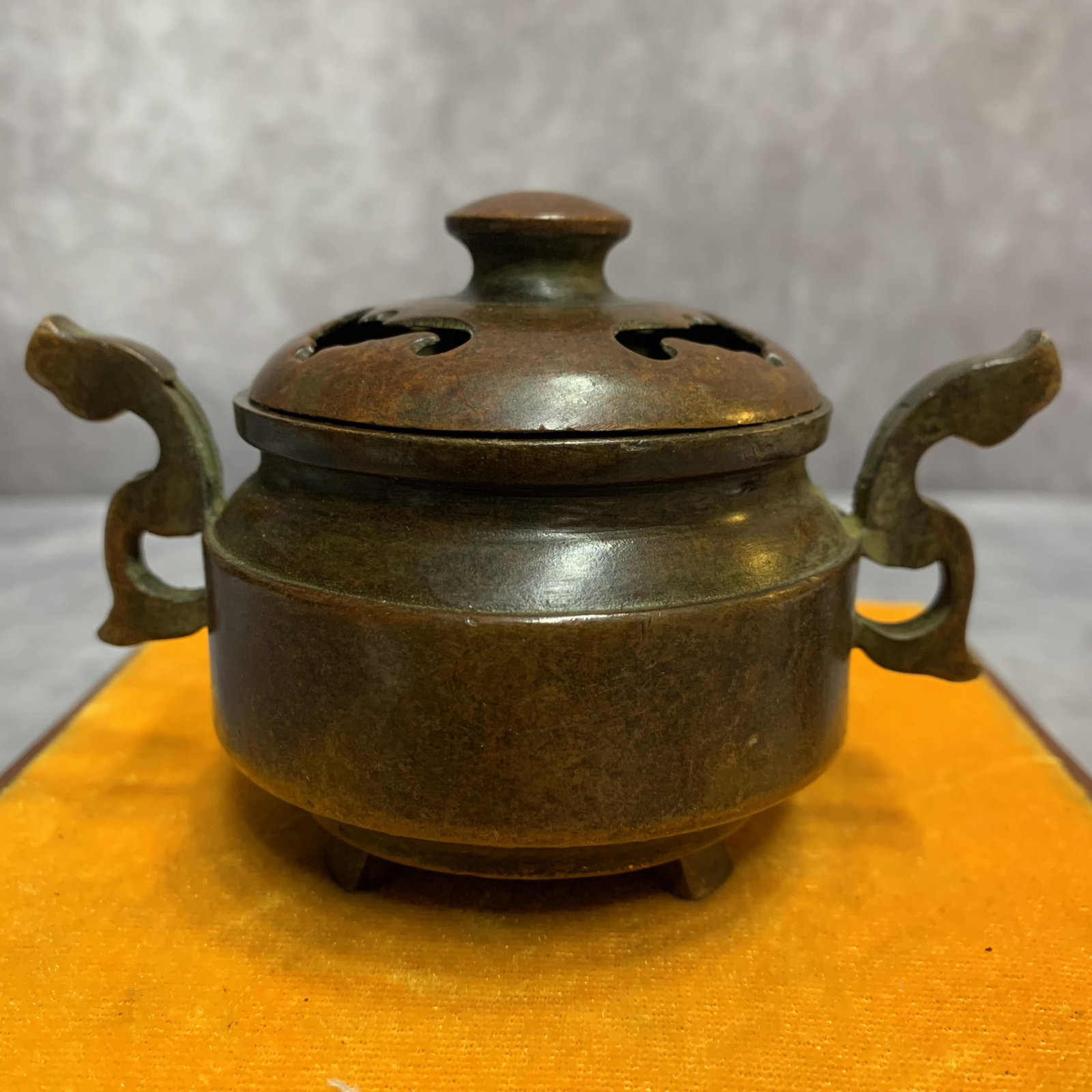A FINE GROUND BRONZE CENSER WITH TWO HANDLE: 20th Century, Width: 4.5 inch High: 2.9 inch Diameter: 2.9 inch; Wooden base for picture and display only.