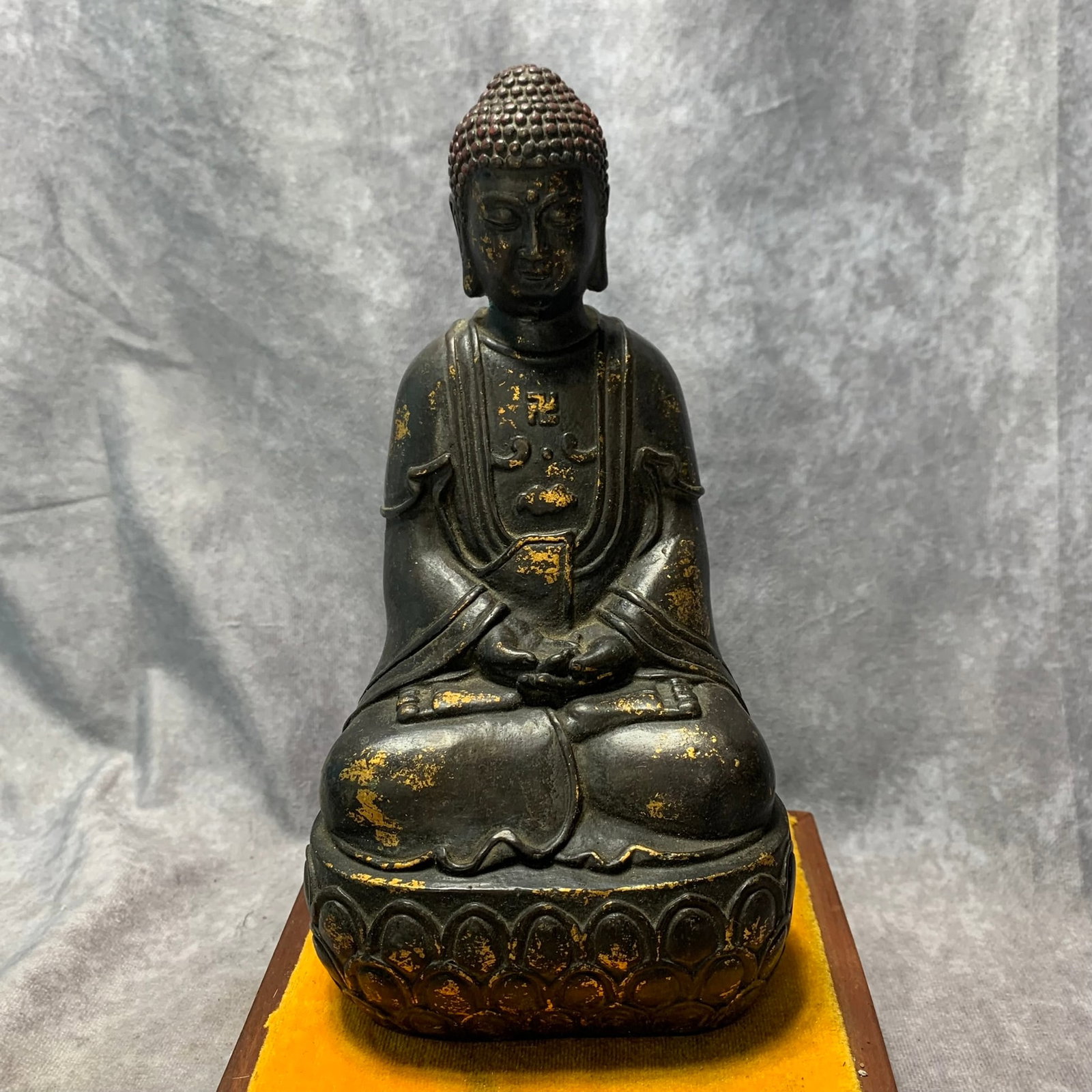 QIAN LONG MARKED GILT BRONZE SAKYAMUNI BUDDHA FIGURE: Qing Dynasty; Long: 4.9 inch; Width: 3.7 inch; High: 8.9 inch. Wooden base for picture and display only.