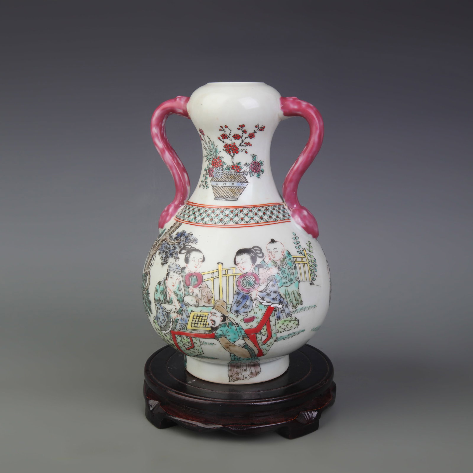 A FAMILLE ROSE GARLIC-MOUTH VASE WITH RUYI-FORM HANDLES: Qing Dynasty; High: 9.2 inch; Wooden base for picture and display only.