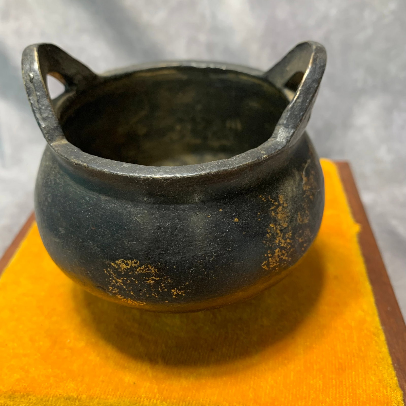 A GILT-BRONZE TRIPOD CENSER WITH LOOP HANDLES, XUANDE MARK: Ming Dynasty Style; High: 3.4 inch; Diameter: 3.9 inch; Wooden base for picture and display only.