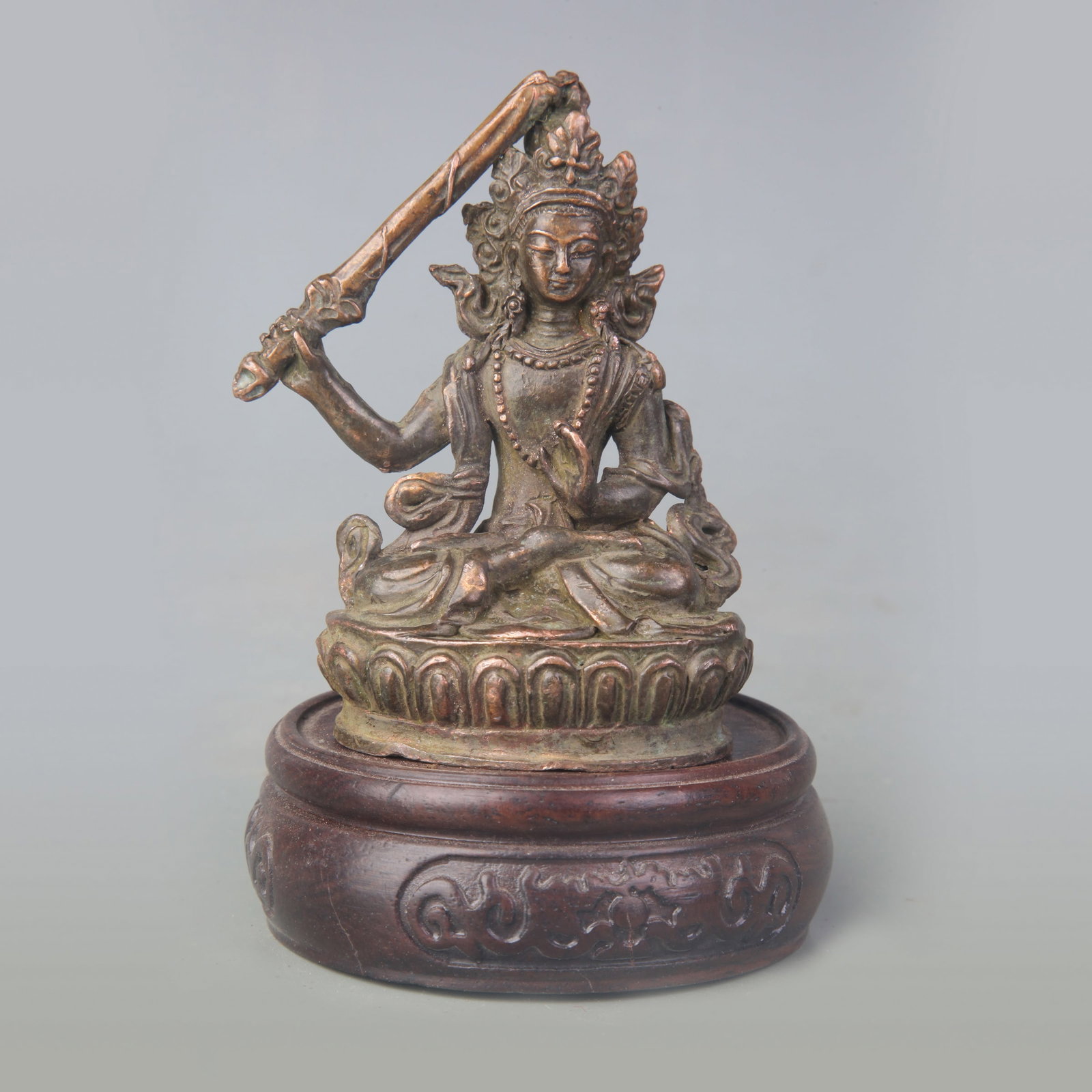 A FINE SMALL BRONZE FIGURE OF MANJUSHRI: Qing Dynasty; High: 3.3 inch; Wooden base for picture and display only.