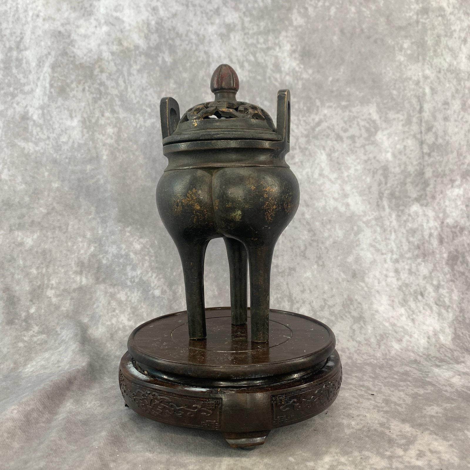 A FINE DING STYLE BRONZE TRIPOD INCENSE BURNER: Ming Dynasty Style; High: 8 inch; Diameter: 4.2 inch. Wooden base for picture and display only.