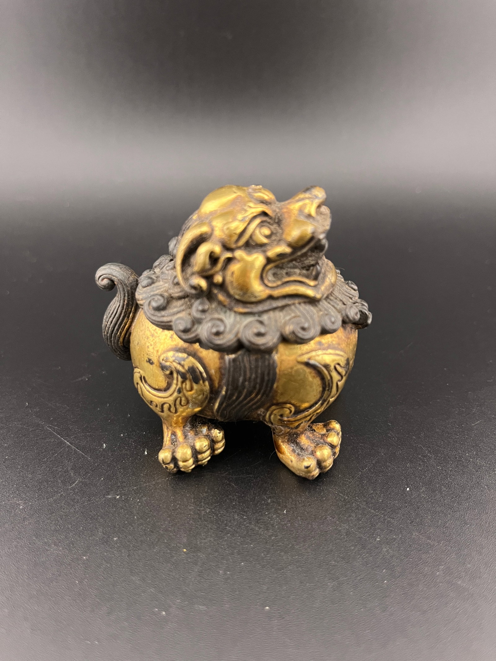 A SMALL BRONZE PIXIU INCENSE BURNER: Modern; Long: 2.2 inch; Width: 1.7 inch; High: 2.1 inch. Wooden base for picture and display only.