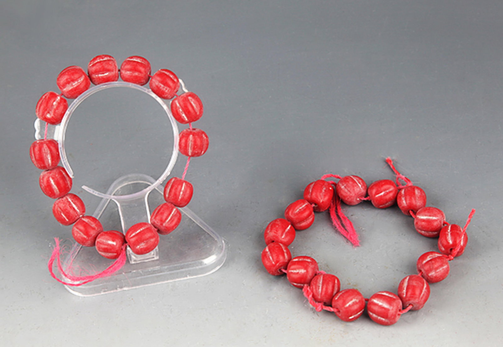 PAIR OF RED COLOR GLASS MADE BRACELETS: Han Dynasty Style; Diameter: 0.5 inch. Wooden base for picture and display only.