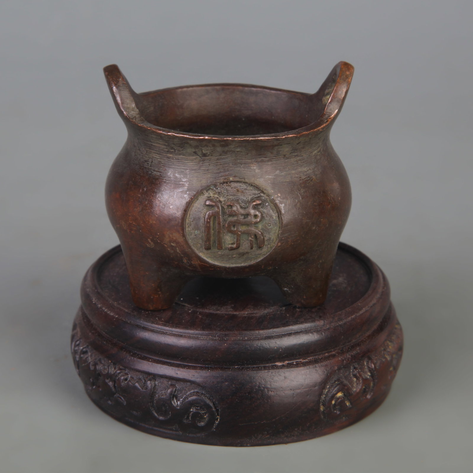 THREE-LEGGED SMALL INCENSE BURNER WITH BRIDGE HANDLES: Qing Dynasty; Width: 2.2 inch; High: 2.1 inch; Wooden base for picture and display only.