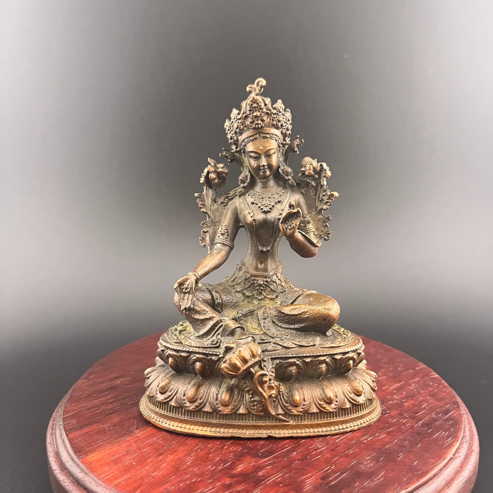 A SMALL BRONZE TIBETAN GREEN TARA STATUE: 19th Century; Long: 2.9 inch; Width: 2 inch; High: 3.87 inch. Wooden base for picture and display only.