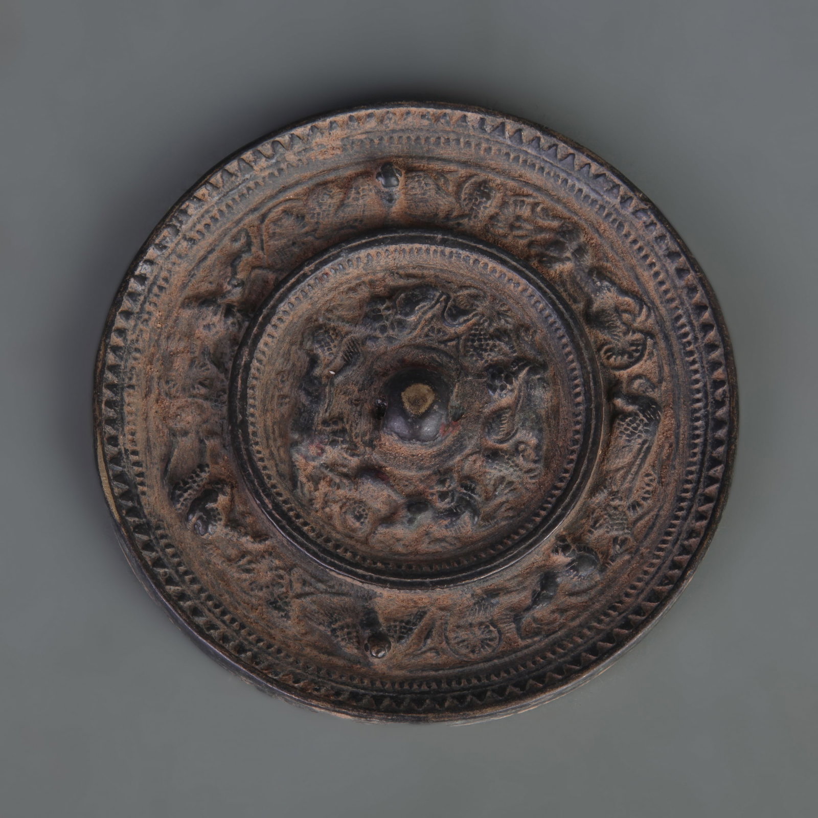 BRONZE MIRROR WITH SEA-CREATURE AND GRAPE DESIGN: Tang Dynasty Style; Diameter: 4.9 inch. Wooden base for picture and display only.