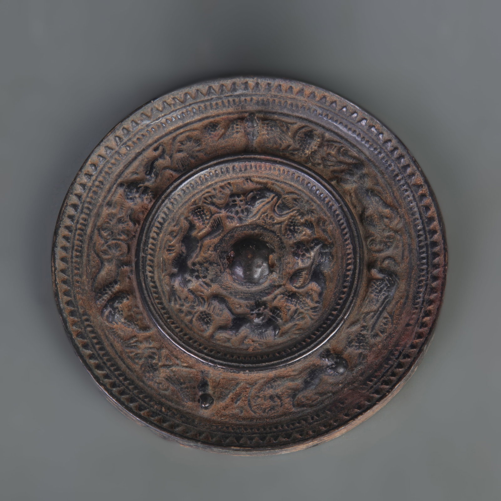BRONZE MIRROR WITH SEA-CREATURE AND GRAPE DESIGN: Tang Dynasty Style; Diameter: 4.9 inch. Wooden base for picture and display only.
