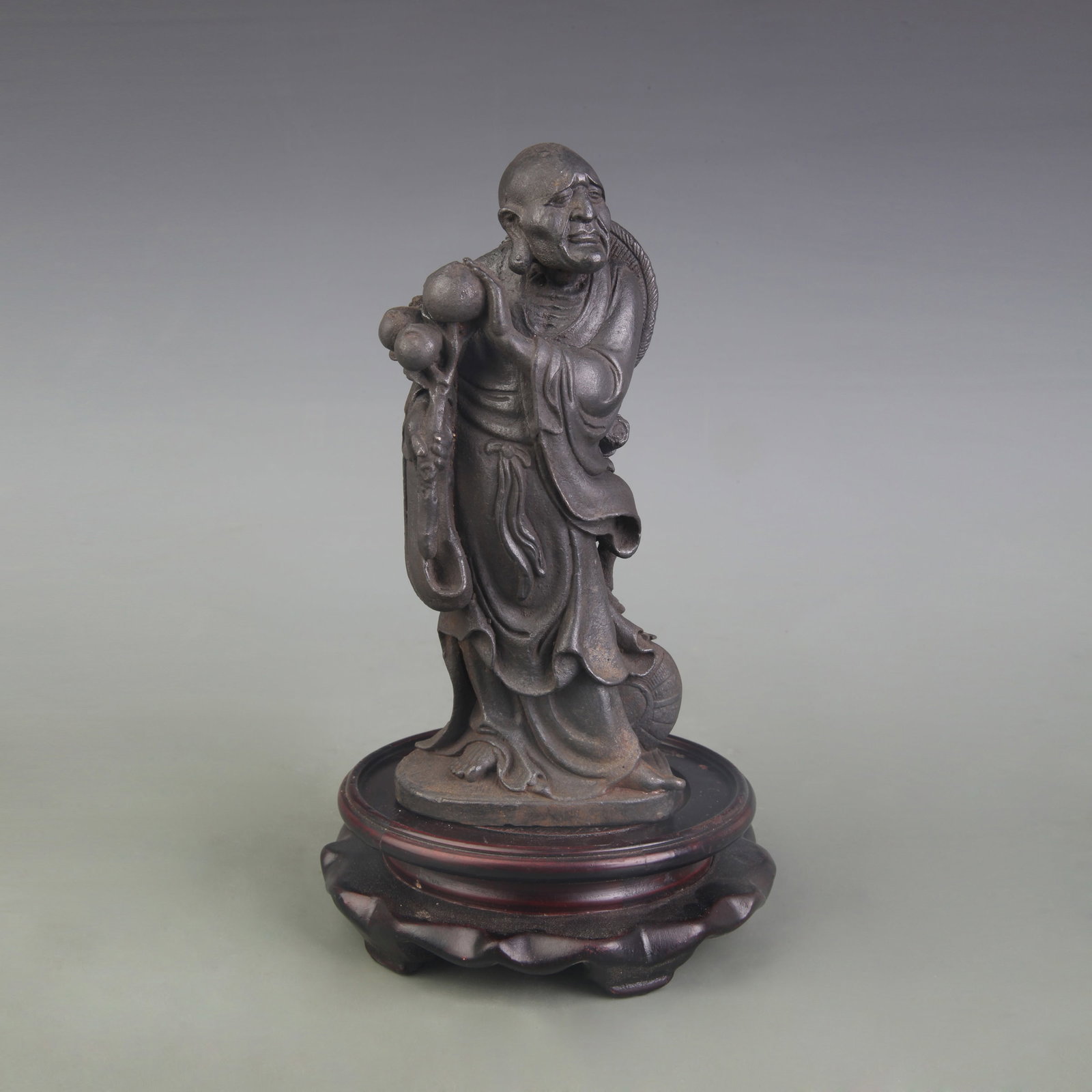 A FINE CAST IRON ARHAT (LUOHAN) STATUE: Qing Dynasty; Width: 3.1 inch; High:7.0 inch; Wooden base for picture and display only.