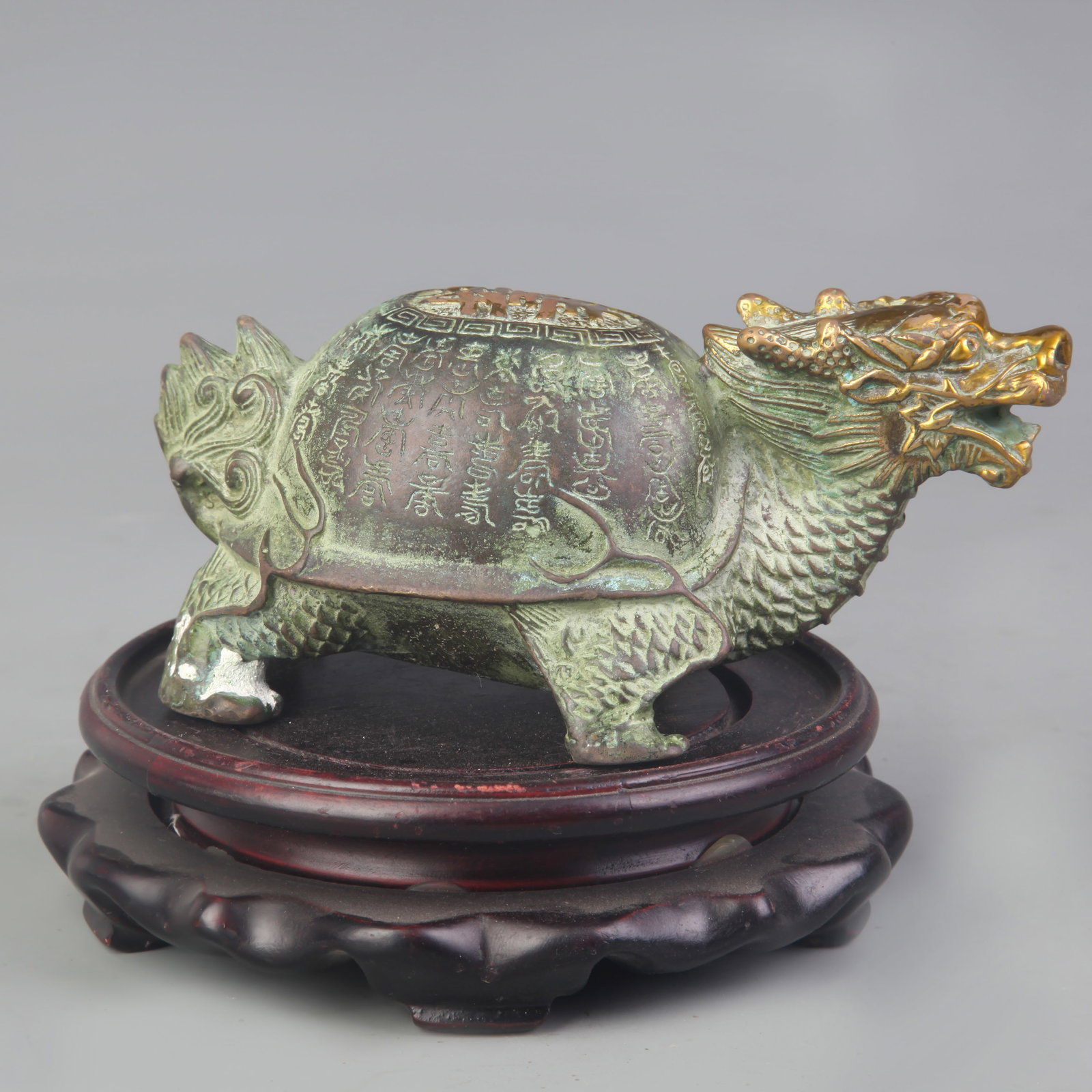A SMALL BRONZE DRAGON TURTLE (LONGGUI) FIGURINE: Modern; Long: 5.5 inch; Width: 3.2 inch; High: 2.3 inch; Wooden base for picture and display only.