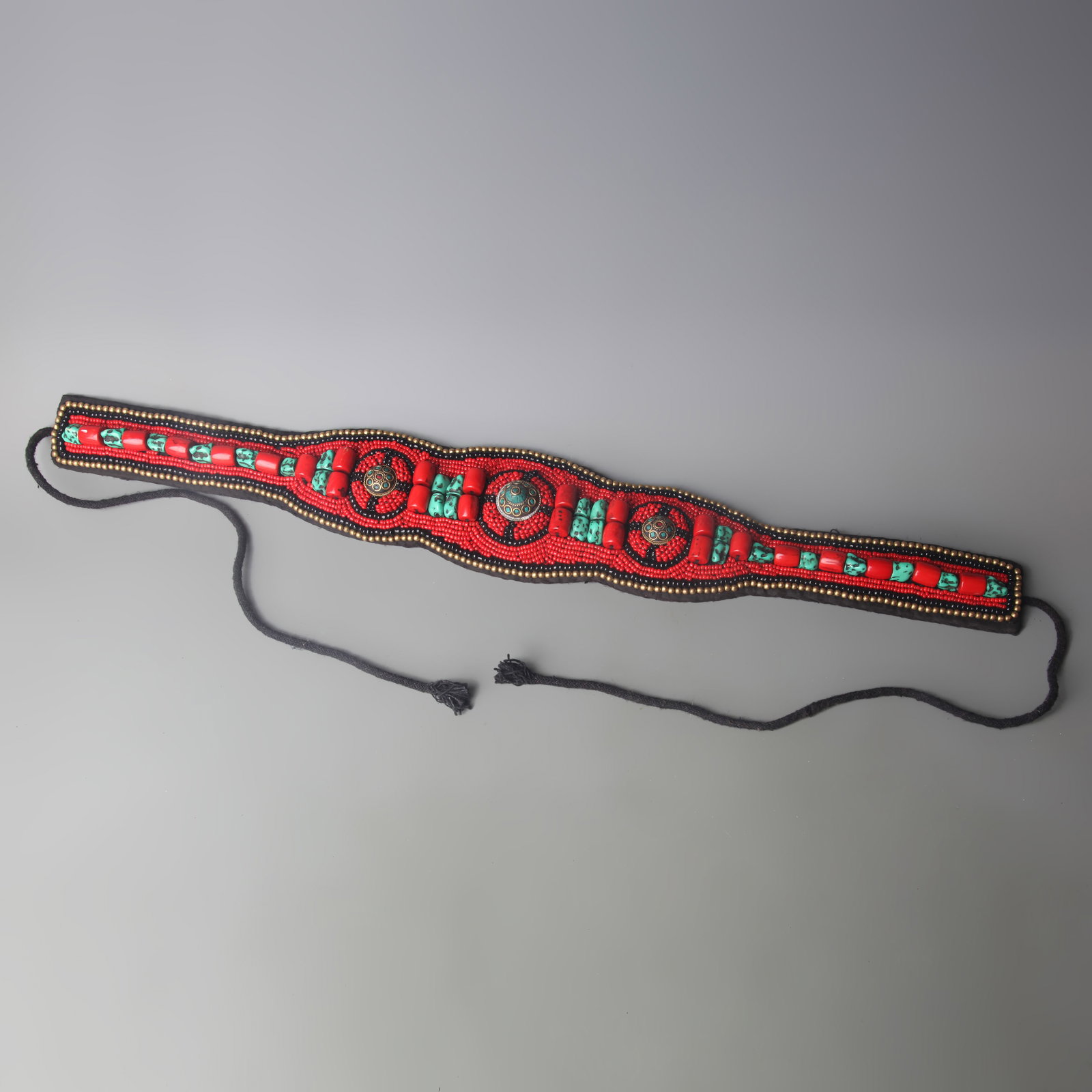 A FINE TIBETAN BUDDHIST BELT WITH RED CORAL AND SHELLS ACCESSORIES: Modern; Long: 24.4 inch; Wooden base for picture and display only.