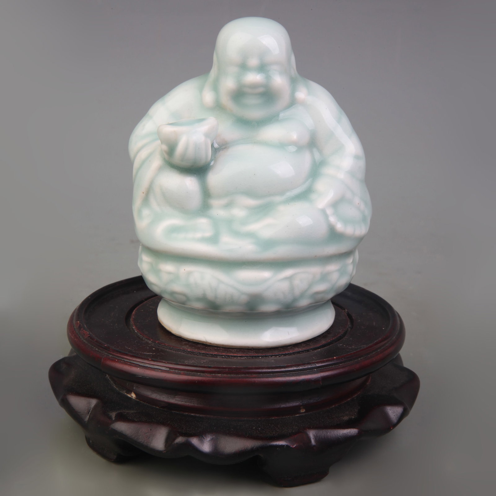 LIGHT BLUE GLAZE PORCELAIN MAITREYA BUDDHA STATUE: Qing Dynasty; High: 4.1 inch. Wooden base for picture and display only.