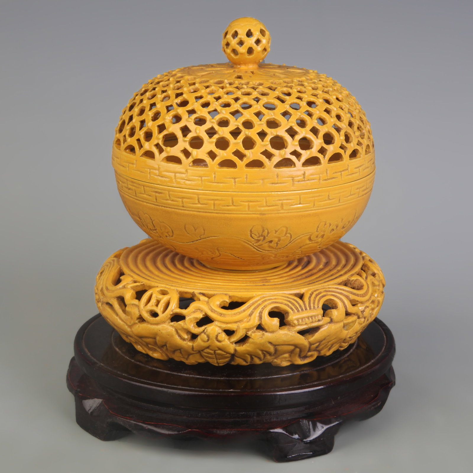 YELLOW GLAZED HOLLOW MADE PORCELAIN INCENSE BURNER: Qing Dynasty Qian Long Period; Diameter: 5.7 inch; High: 5.8 inch. Wooden base for picture and display only.