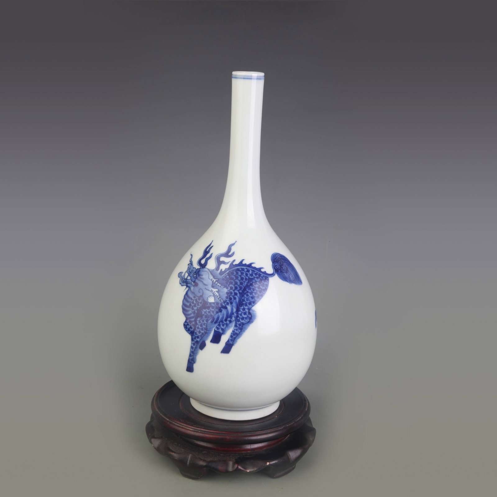 A BLUE AND WHITE VASE WITH MYTHICAL BEAST MOTIF: Qing Dynasty; Diameter: 2.7 inch; High: 10.0 inch; Wooden base for picture and display only.