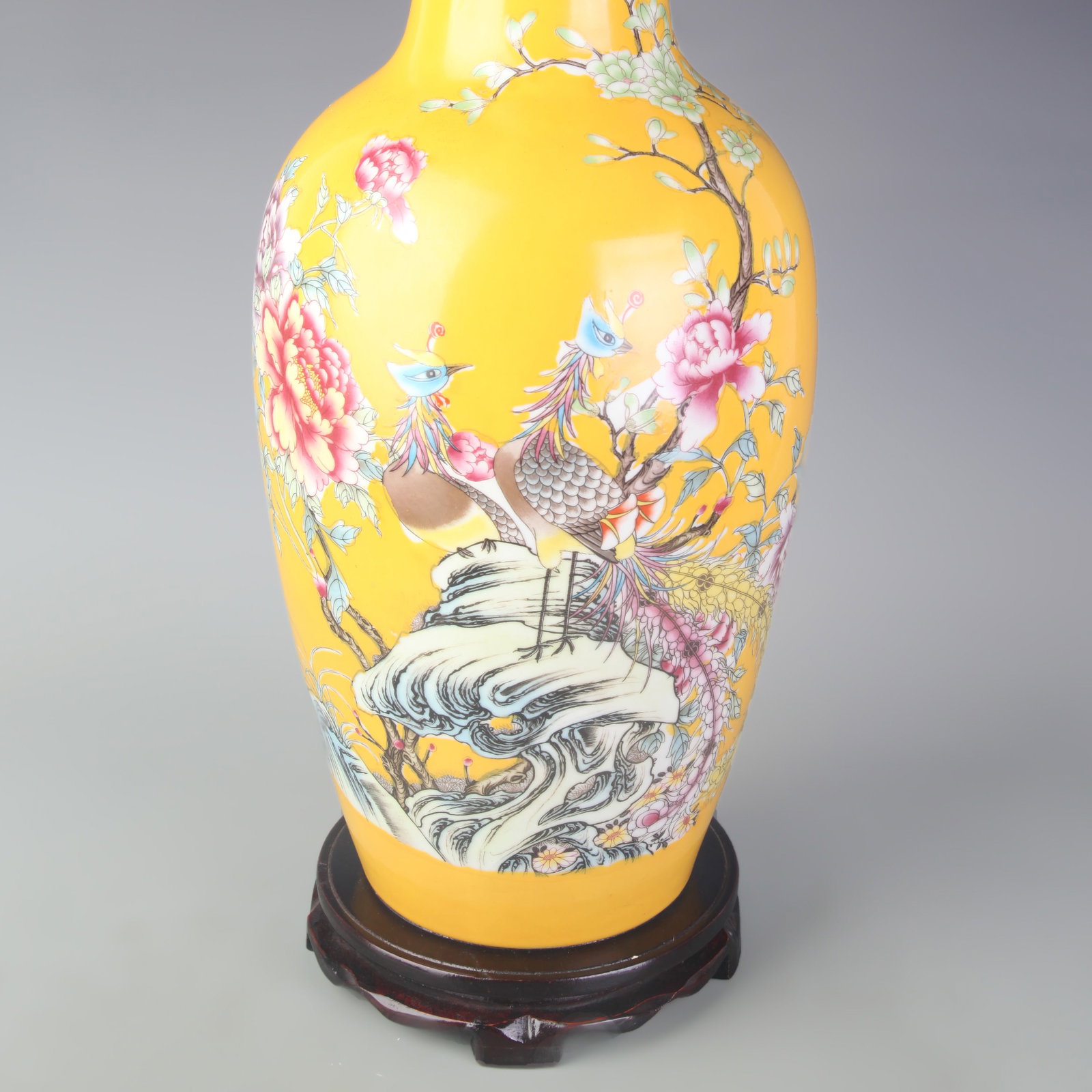 A FAMILLE ROSE YELLOW-GROUND VASE WITH PHOENIX AND FLORAL MOTIFS: Qing Dynasty; High: 17.0 inch; Wooden base for picture and display only.