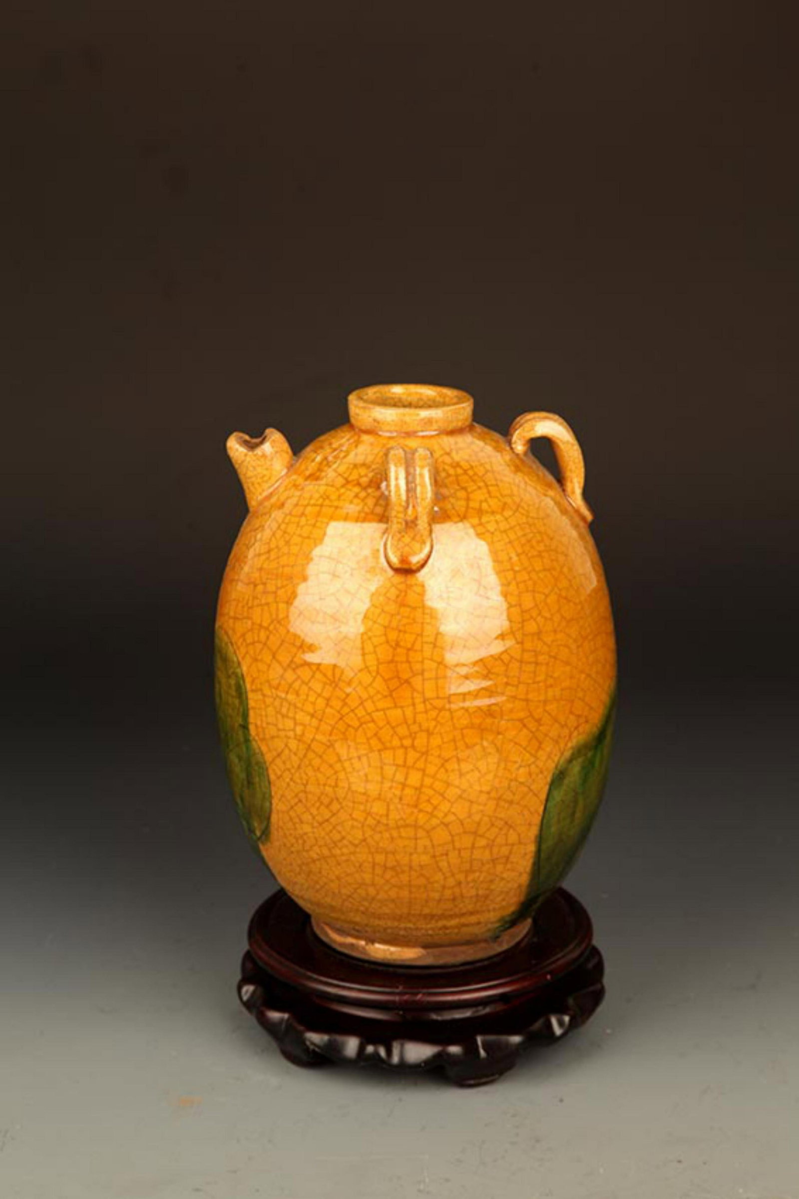 A YELLOW GLAZED ROUND PORCELAIN JAR: Song Dynasty Style, High: 7.5 inch; Diameter: 1.5 inch. Wooden base for picture and display only.