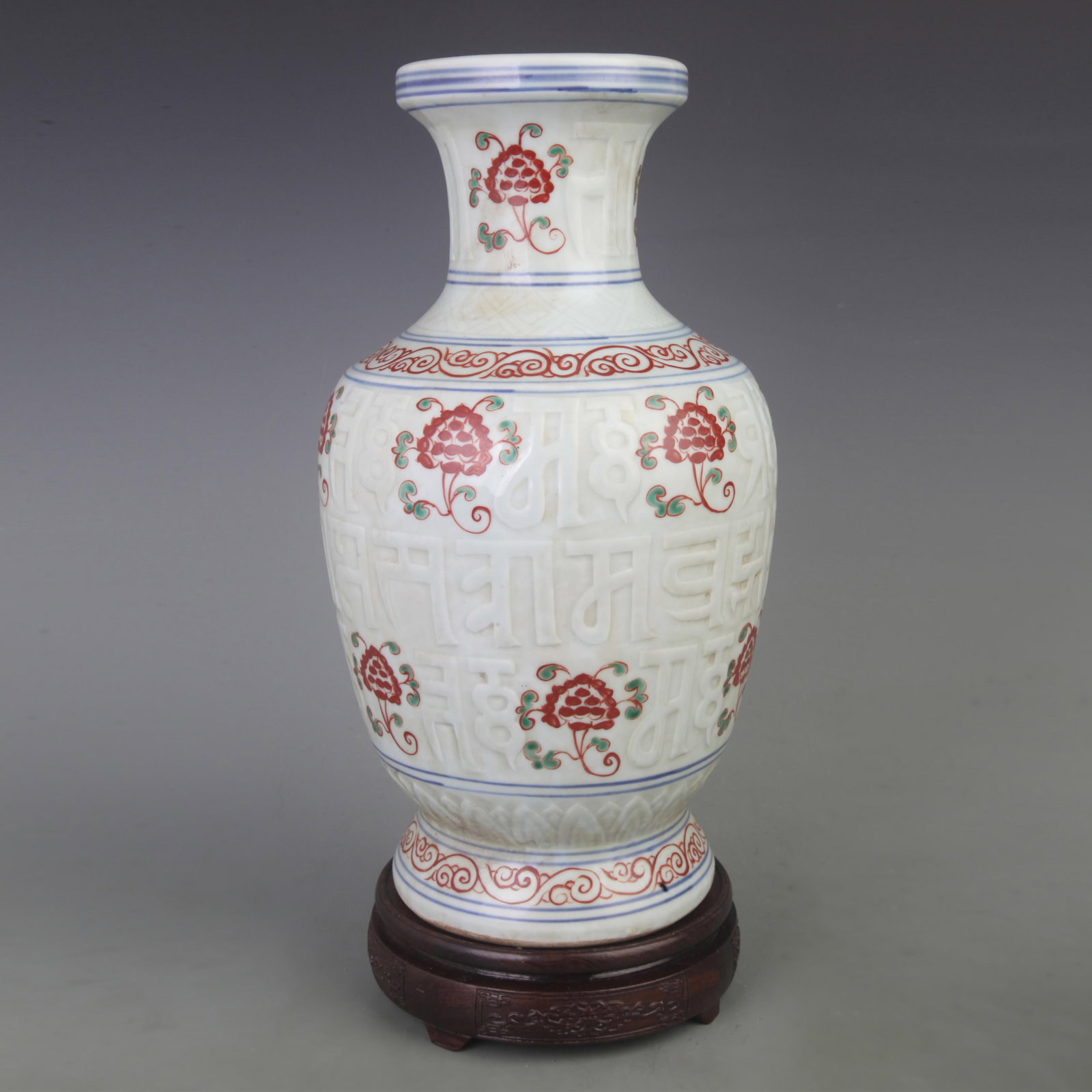 A WUCAI PORCELAIN VASE WITH INCISED FLORAL DECORATION: Ming Dynasty Xuan De Period; Diameter: 7.3 inch; High: 14.0 inch; Wooden base for picture and display only.