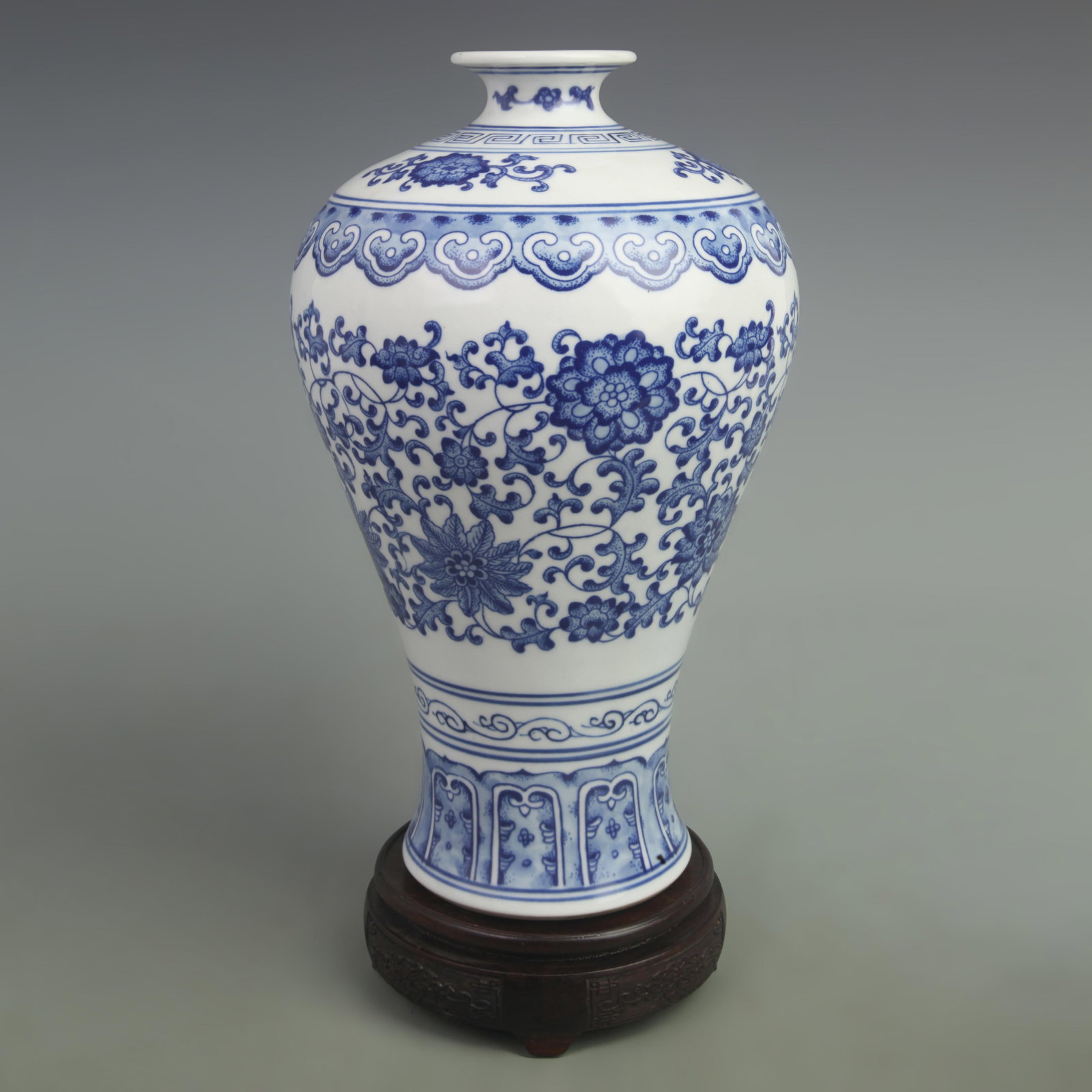 BLUE AND WHITE MEI STYLE PORCELAIN VASE WITH INTERTWINED LOTUS PATTERN: Qing Dynasty Yong Zheng Period, High: 12.2 inch; Width: 8 inch. Wooden base for picture and display only.