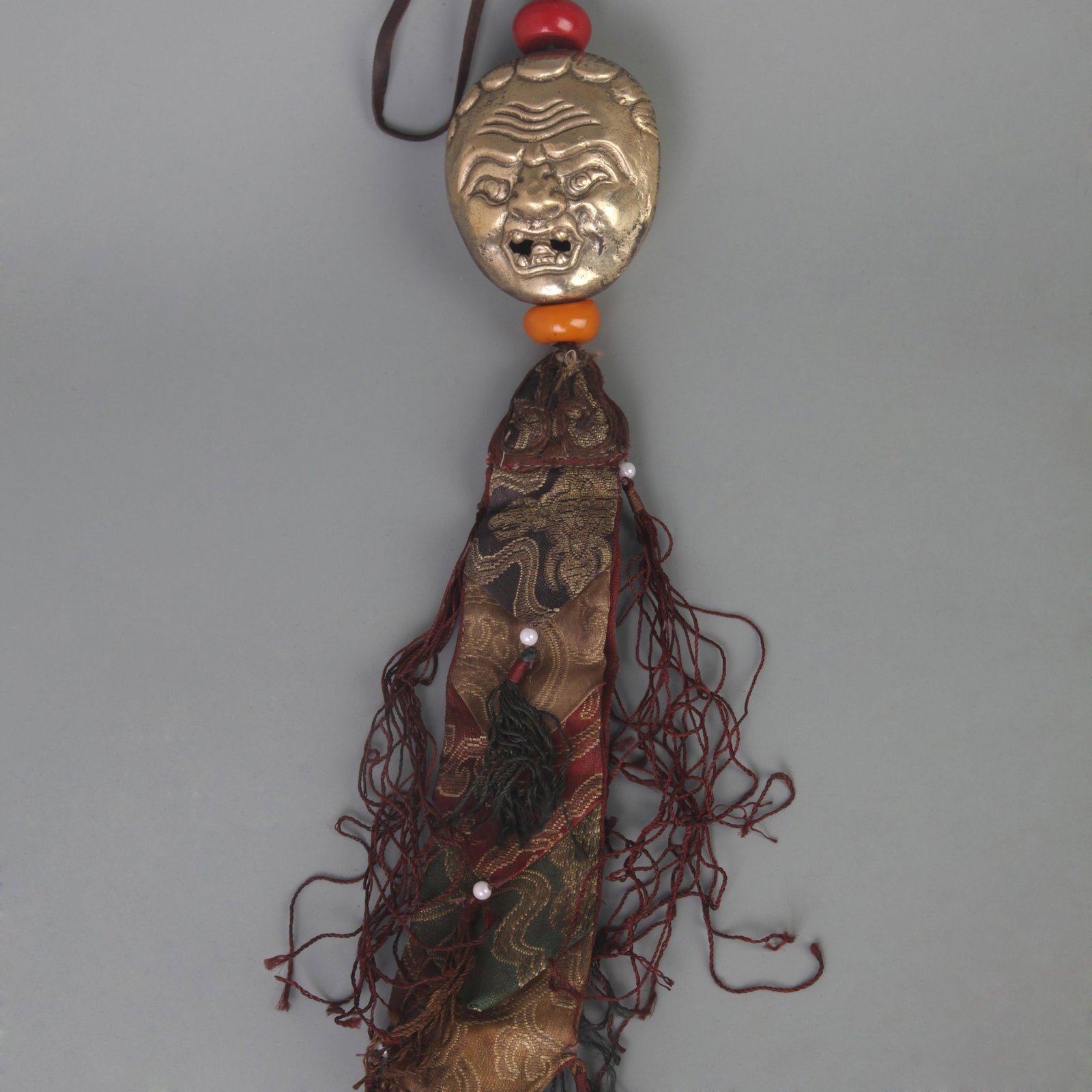 A FINE BRONZE TIBETAN BUDDHIST PROTECTIVE AMULET TASSEL: Qing Dynasty; Long:3.0inch; Width: 2.6inch; Wooden base for picture and display only.