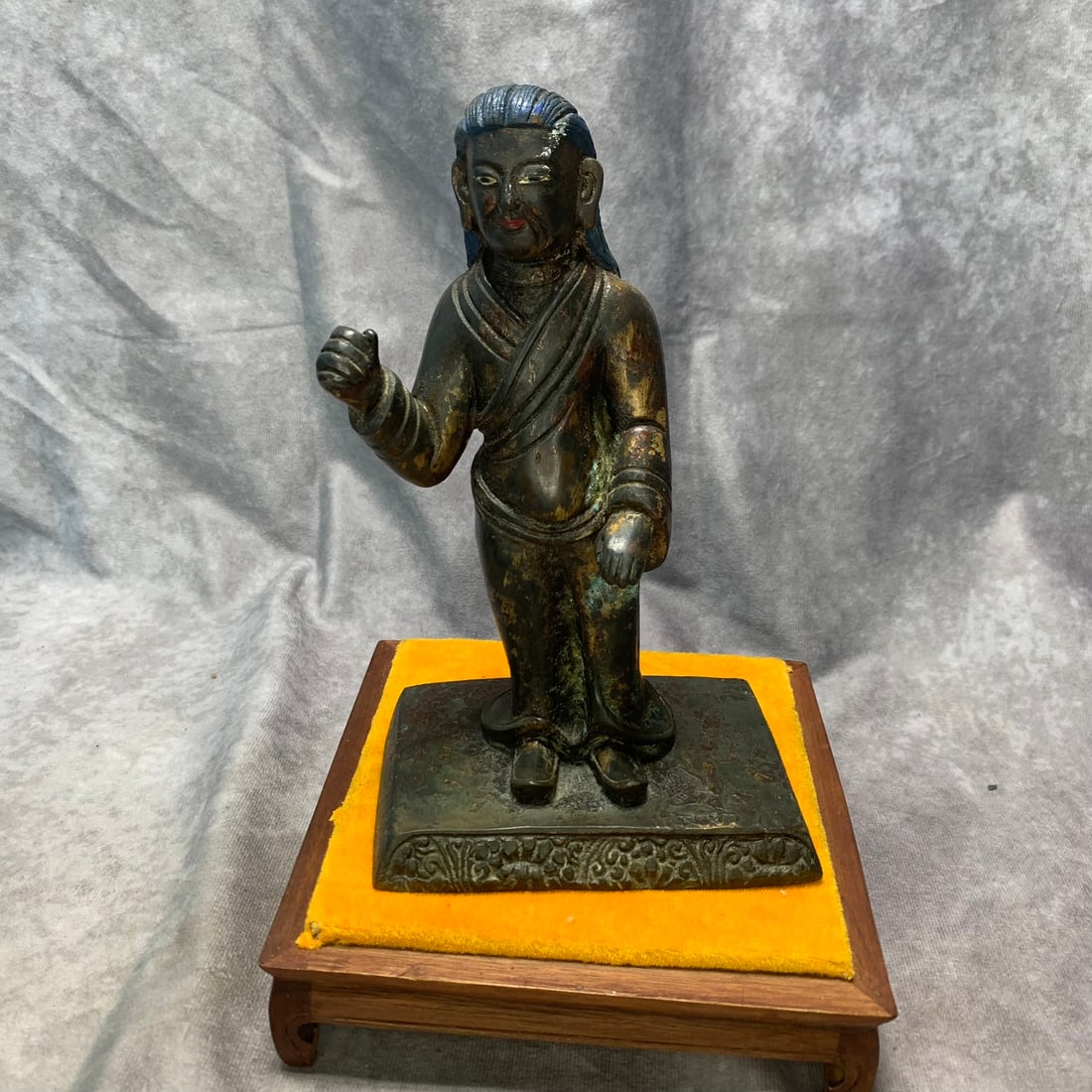 A GILT-BRONZE TIBETAN MILAREPA FIGURE: Ming Dynasty Style; Long: 5 inch; High: 8.1 inch. Wooden base for picture and display only.