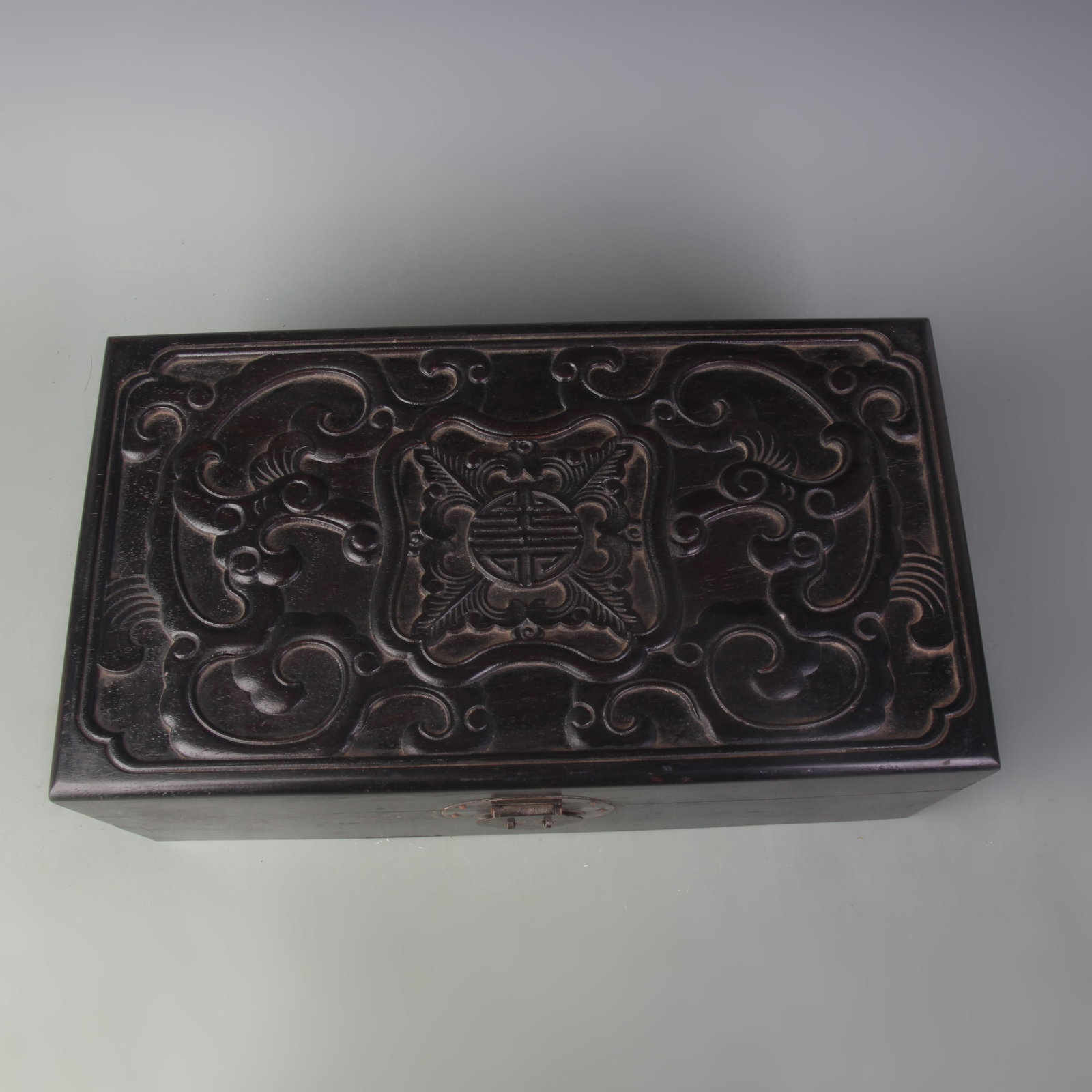 A SANDALWOOD BOX CARVED WITH LONGEVITY AND BLESSING MOTIFS: Qing Dynasty; Long: 14.0 inch; Width: 1.8 inch; High: 5.1 inch; Wooden base for picture and display only.